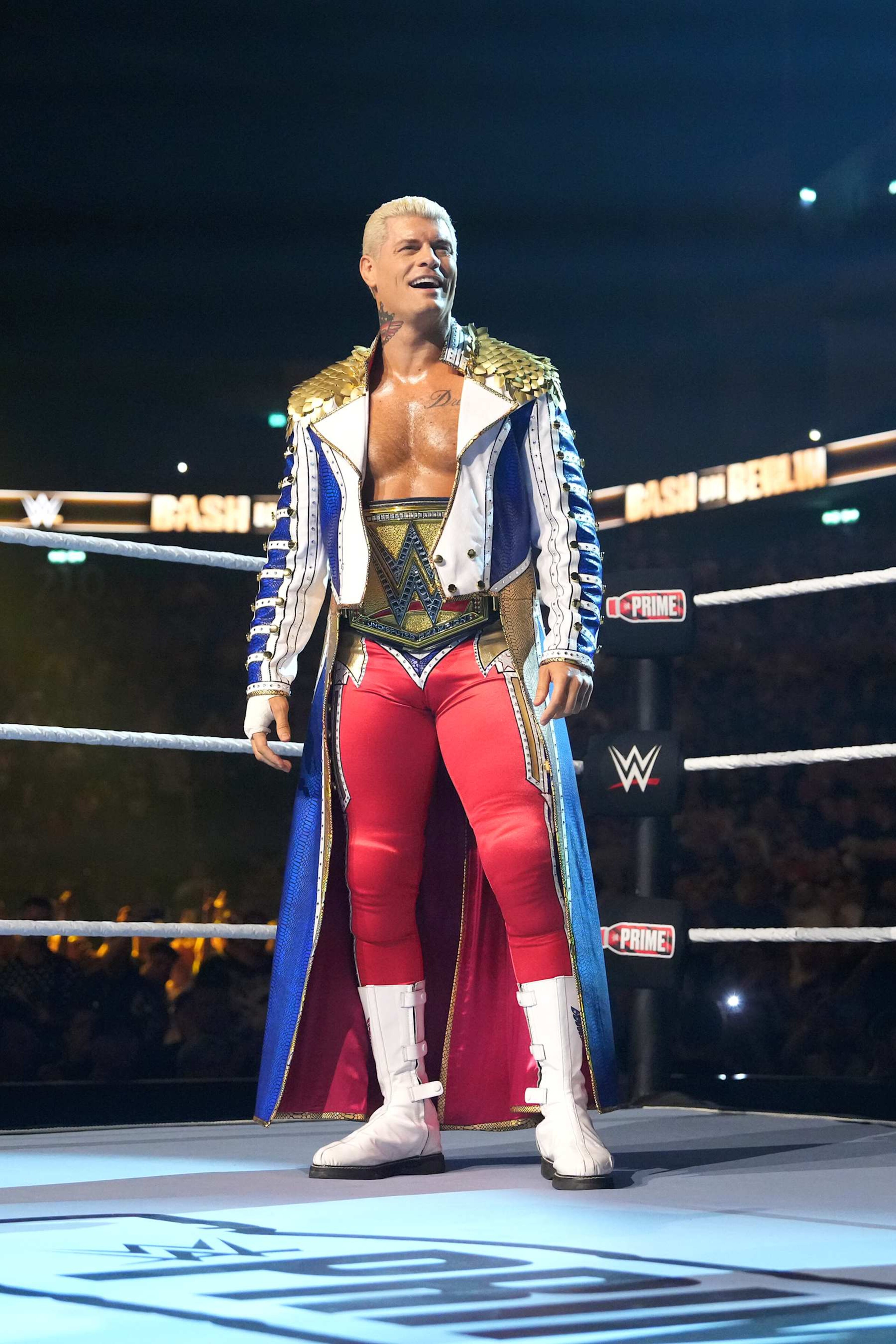 BERLIN, GERMANY - AUGUST 31: WWE Undisputed Universal Champion Cody Rhodes smiles during his entrance during the WWE Bash in Berlin Premium Live Event at Uber Arena on August 31, 2024 in Berlin, Germany.  (Photo by WWE/Getty Images)