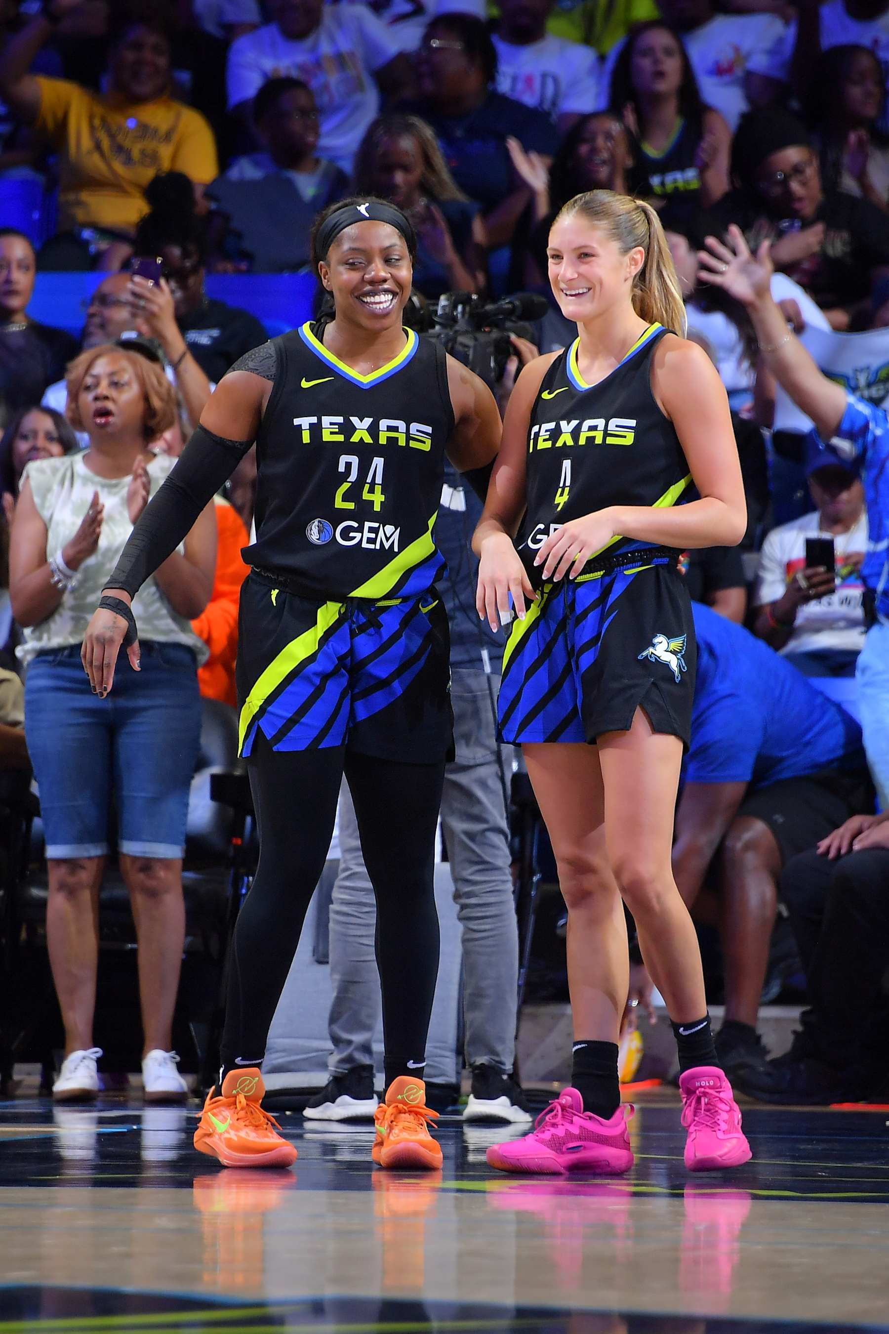 ARLINGTON, TX - JULY 5: Arike Ogunbowale #24 and Jacy Sheldon #4 of the Dallas Wings celebrates during the game against the Atlanta Dream on July 5, 2024 at the College Park Center in Arlington, TX. NOTE TO USER: User expressly acknowledges and agrees that, by downloading and or using this photograph, User is consenting to the terms and conditions of the Getty Images License Agreement. Mandatory Copyright Notice: Copyright 2024 NBAE (Photo by Michael Gonzales/NBAE via Getty Images)