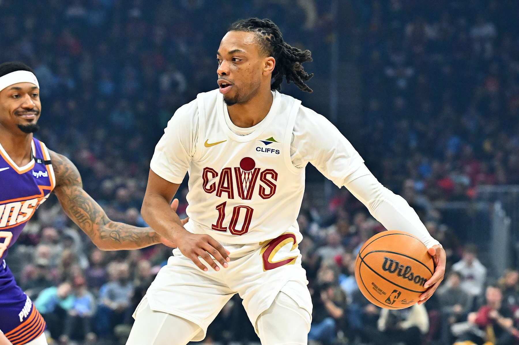 CLEVELAND, OHIO - JANUARY 20: Darius Garland #10 of the Cleveland Cavaliers drives to the basket around Bradley Beal #3 of the Phoenix Suns during the first quarter at Rocket Mortgage Fieldhouse on January 20, 2025 in Cleveland, Ohio. NOTE TO USER: User expressly acknowledges and agrees that, by downloading and or using this photograph, User is consenting to the terms and conditions of the Getty Images License Agreement. (Photo by Jason Miller/Getty Images)