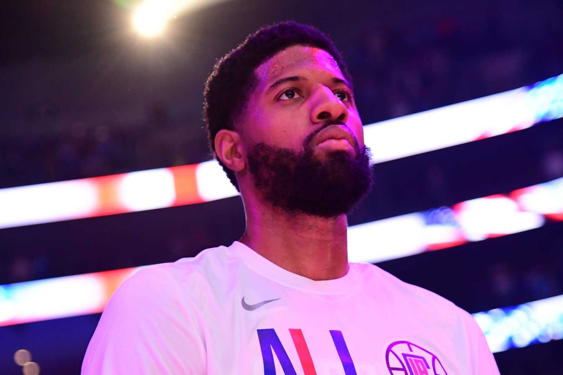 LOS ANGELES, CA - APRIL 21:  Paul George #13 of the LA Clippers stands for the National Anthem before the game against the Dallas Mavericks during Round 1 Game 1 of the 2024 NBA Playoffs on April 21, 2024 at Crypto.Com Arena in Los Angeles, California. NOTE TO USER: User expressly acknowledges and agrees that, by downloading and/or using this Photograph, user is consenting to the terms and conditions of the Getty Images License Agreement. Mandatory Copyright Notice: Copyright 2024 NBAE (Photo by Adam Pantozzi/NBAE via Getty Images)