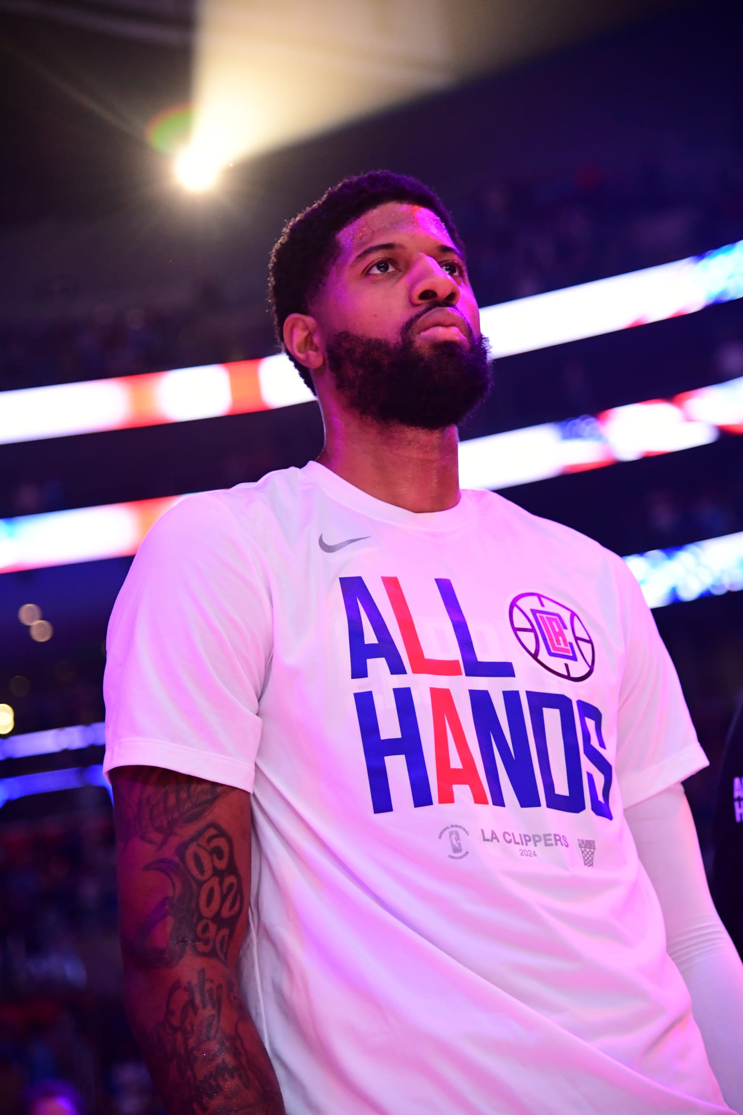 LOS ANGELES, CA - APRIL 21:  Paul George #13 of the LA Clippers stands for the National Anthem before the game against the Dallas Mavericks during Round 1 Game 1 of the 2024 NBA Playoffs on April 21, 2024 at Crypto.Com Arena in Los Angeles, California. NOTE TO USER: User expressly acknowledges and agrees that, by downloading and/or using this Photograph, user is consenting to the terms and conditions of the Getty Images License Agreement. Mandatory Copyright Notice: Copyright 2024 NBAE (Photo by Adam Pantozzi/NBAE via Getty Images)