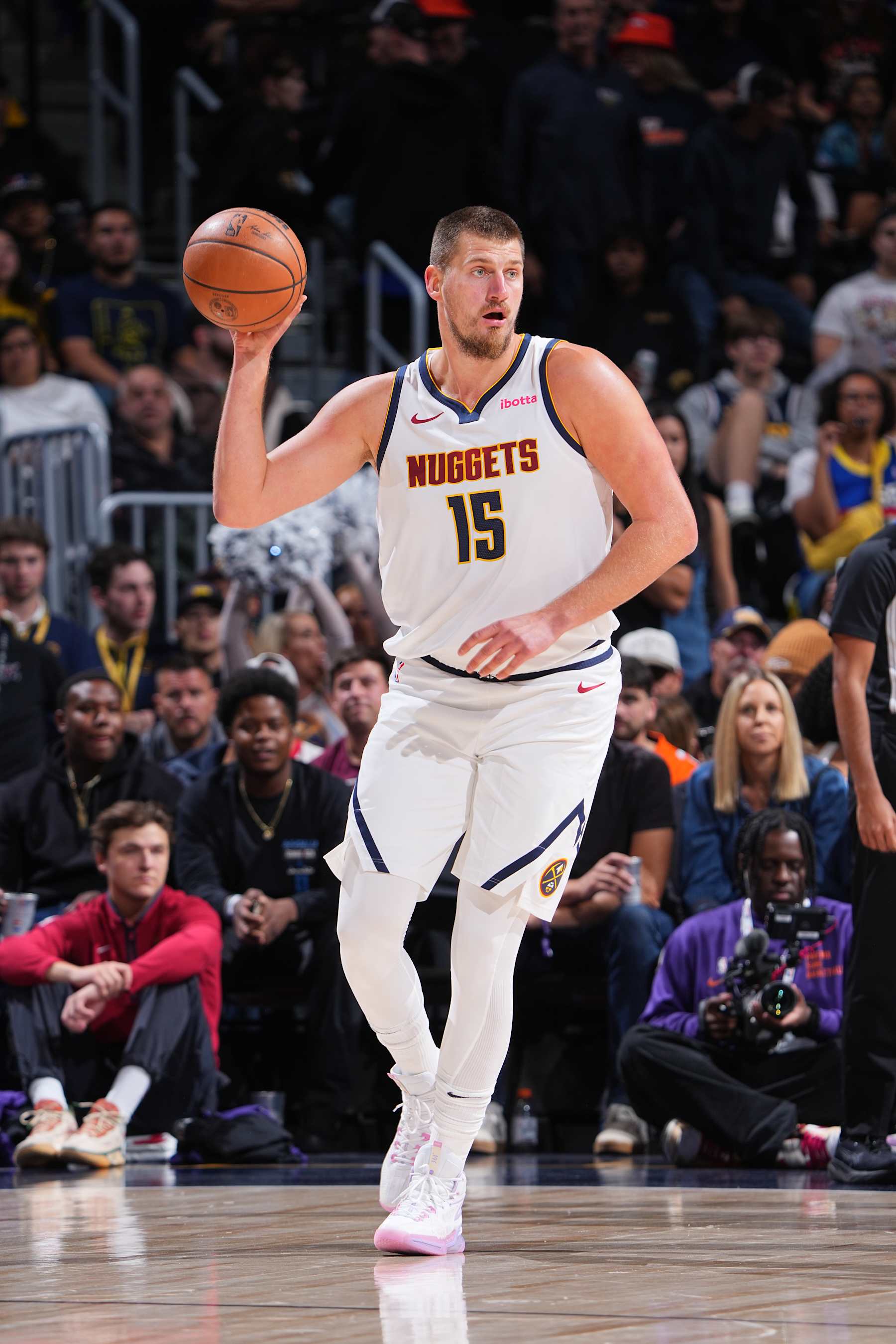 DENVER, CO - OCTOBER 13: Nikola Jokic #15 of the Denver Nuggets looks to pass the ball during the game against the Phoenix Suns on October 13, 2024 at Ball Arena in Denver, Colorado. NOTE TO USER: User expressly acknowledges and agrees that, by downloading and/or using this Photograph, user is consenting to the terms and conditions of the Getty Images License Agreement. Mandatory Copyright Notice: Copyright 2024 NBAE (Photo by Garrett Ellwood/NBAE via Getty Images)