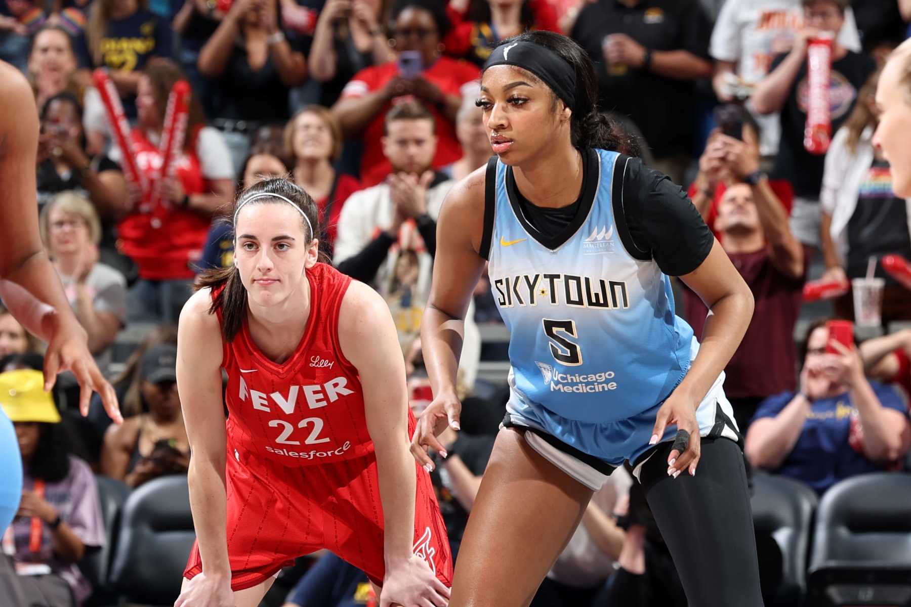 INDIANAPOLIS, IN - JUNE 1: Caitlin Clark #22 of the Indiana Fever and Angel Reese #5 of the Chicago Sky look on during the game on June 1, 2024 at Gainbridge Fieldhouse in Indianapolis, Indiana. NOTE TO USER: User expressly acknowledges and agrees that, by downloading and or using this Photograph, user is consenting to the terms and conditions of the Getty Images License Agreement. Mandatory Copyright Notice: Copyright 2024 NBAE (Photo by Jeff Haynes/NBAE via Getty Images)