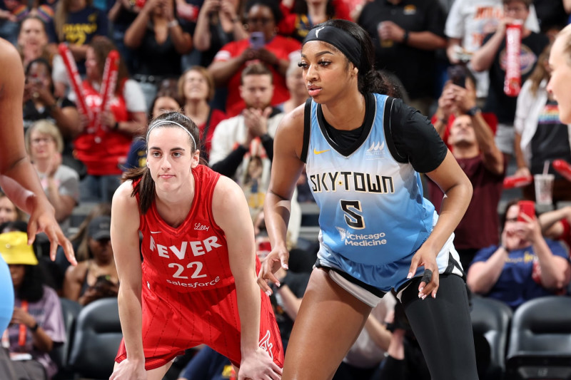 INDIANAPOLIS, IN - JUNE 1: Caitlin Clark #22 of the Indiana Fever and Angel Reese #5 of the Chicago Sky look on during the game on June 1, 2024 at Gainbridge Fieldhouse in Indianapolis, Indiana. NOTE TO USER: User expressly acknowledges and agrees that, by downloading and or using this Photograph, user is consenting to the terms and conditions of the Getty Images License Agreement. Mandatory Copyright Notice: Copyright 2024 NBAE (Photo by Jeff Haynes/NBAE via Getty Images)