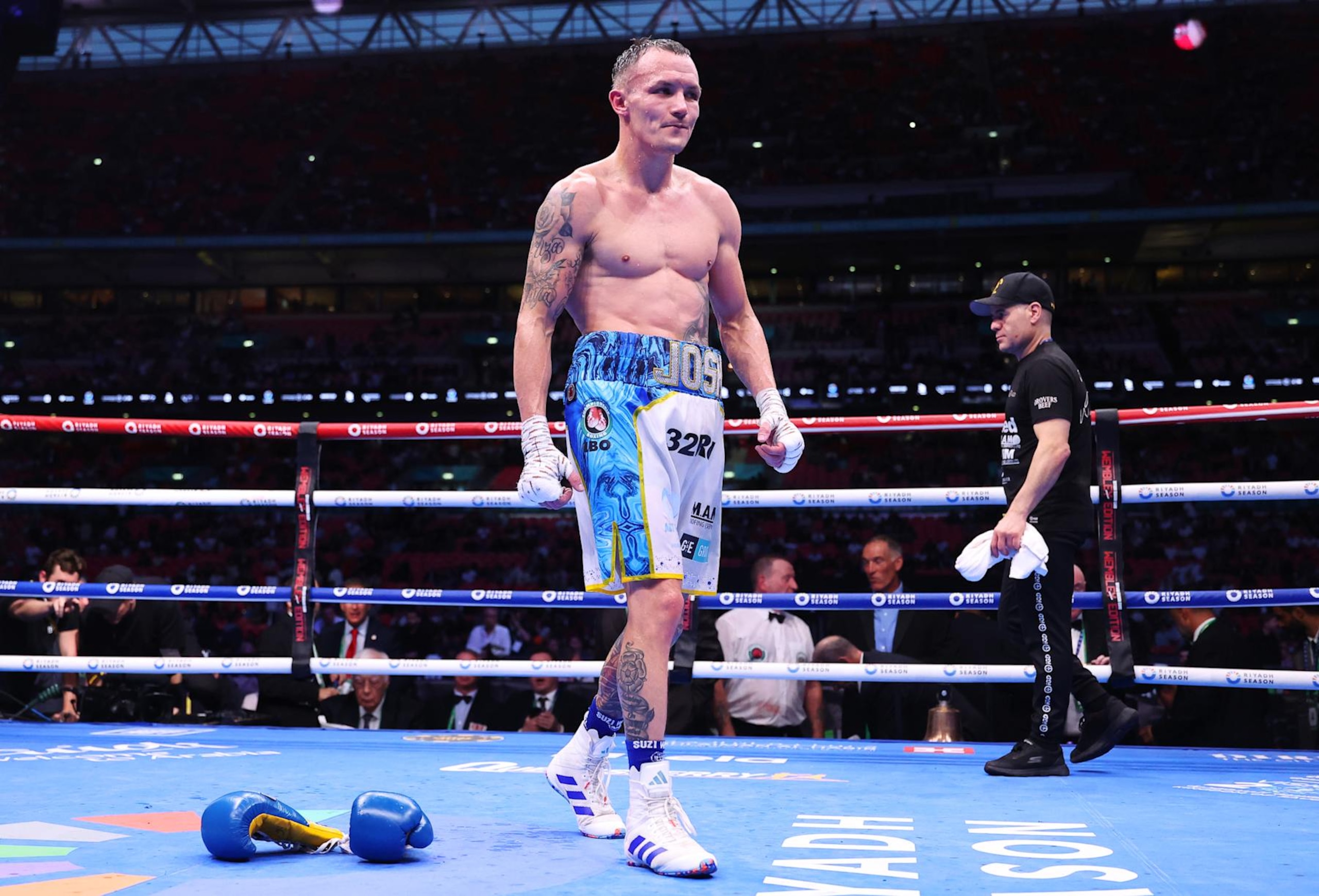 LONDON, ENGLAND - SEPTEMBER 21: Josh Warrington walks out of the ring after throwing his gloves down as he reacts to defeat to Anthony Cacace (not pictured) in the IBO World Super Featherweight Title fight between Anthony Cacace and Josh Warrington , on the Riyadh Season  - Wembley Edition card at Wembley Stadium on September 21, 2024 in London, England. (Photo by Richard Pelham/Getty Images)