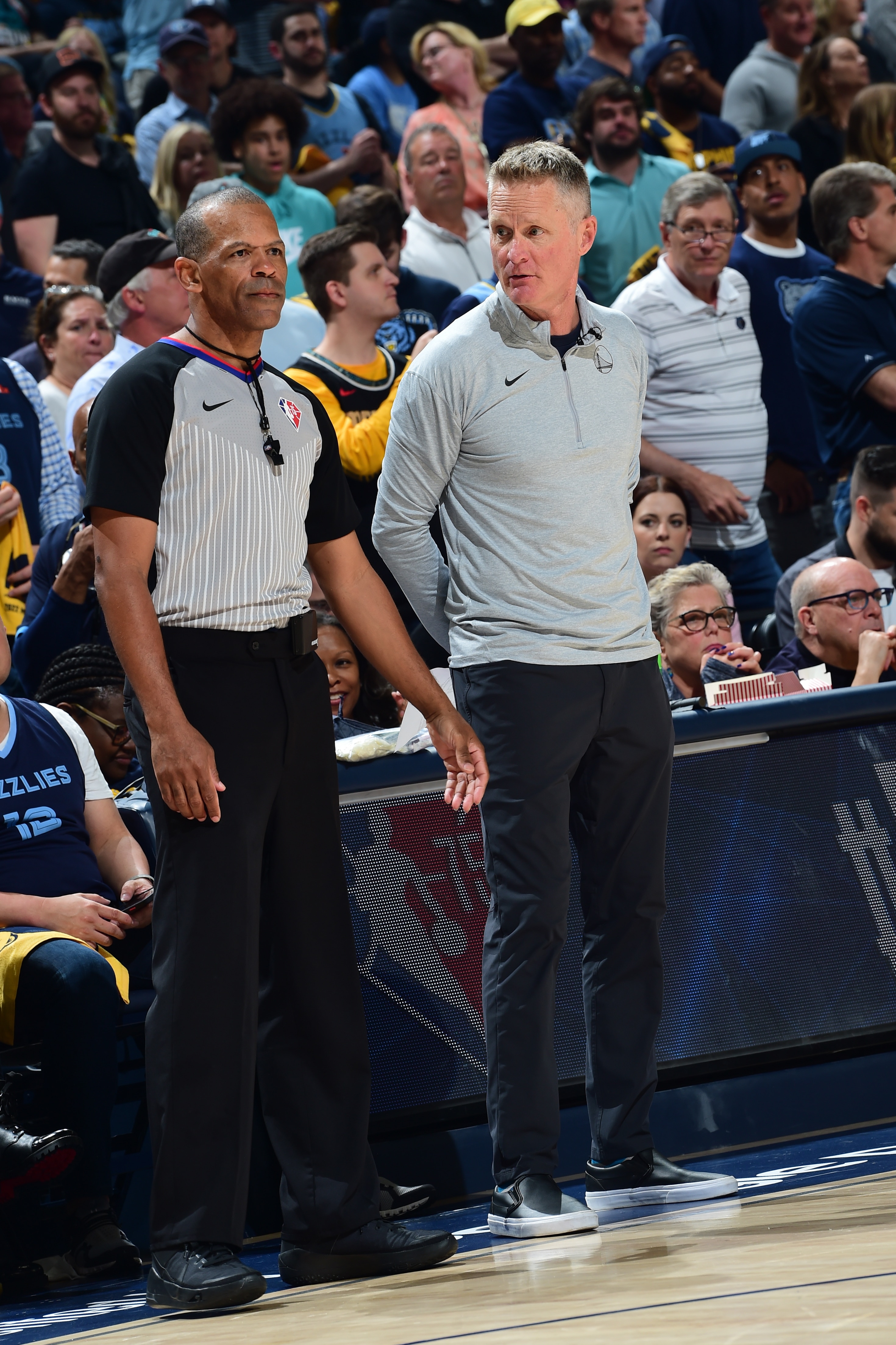 MEMPHIS, TN - MAY 3: NBA referee Eric Lewis #42 and Head Coach Steve Kerr of the Golden State Warriors look on during the game against the Memphis Grizzlies during Game 2 of the 2022 NBA Playoffs Western Conference Semifinals on May 3, 2022 at FedExForum in Memphis, Tennessee. NOTE TO USER: User expressly acknowledges and agrees that, by downloading and or using this photograph, user is consenting to the terms and conditions of Getty Images License Agreement. Mandatory Copyright Notice: Copyright 2022 NBAE (Photo by Noah Graham/NBAE via Getty Images)