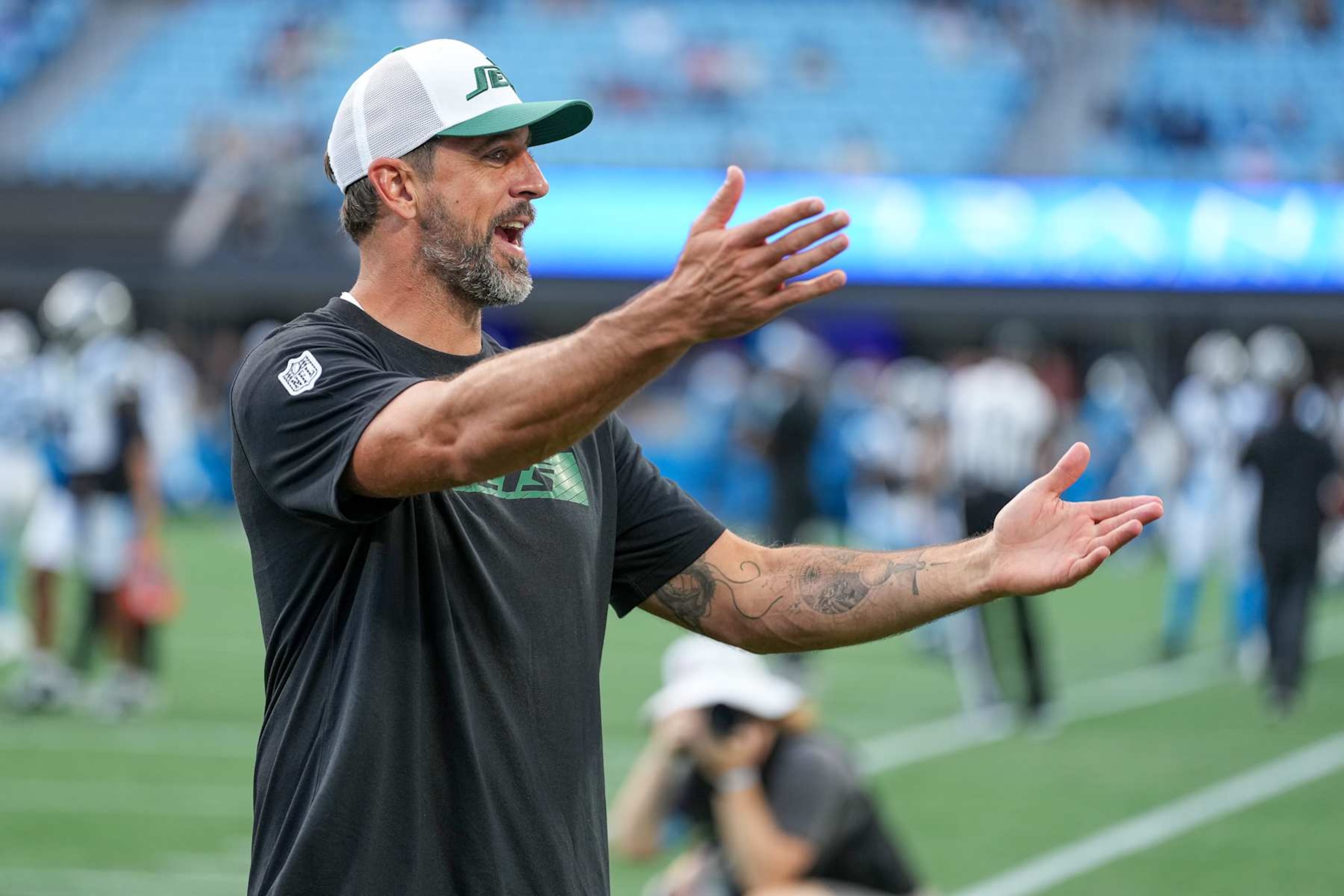 CHARLOTTE, NORTH CAROLINA - AUGUST 17: Aaron Rodgers #8 of the New York Jets jokes with fans before their preseason game against the Carolina Panthers at Bank of America Stadium on August 17, 2024 in Charlotte, North Carolina. (Photo by Grant Halverson/Getty Images) CHARLOTTE, NORTH CAROLINA - AUGUST 17: Aaron Rodgers #8 of the New York Jets jokes with fans before their preseason game against the Carolina Panthers at Bank of America Stadium on August 17, 2024 in Charlotte, North Carolina. (Photo by Grant Halverson/Getty Images)
