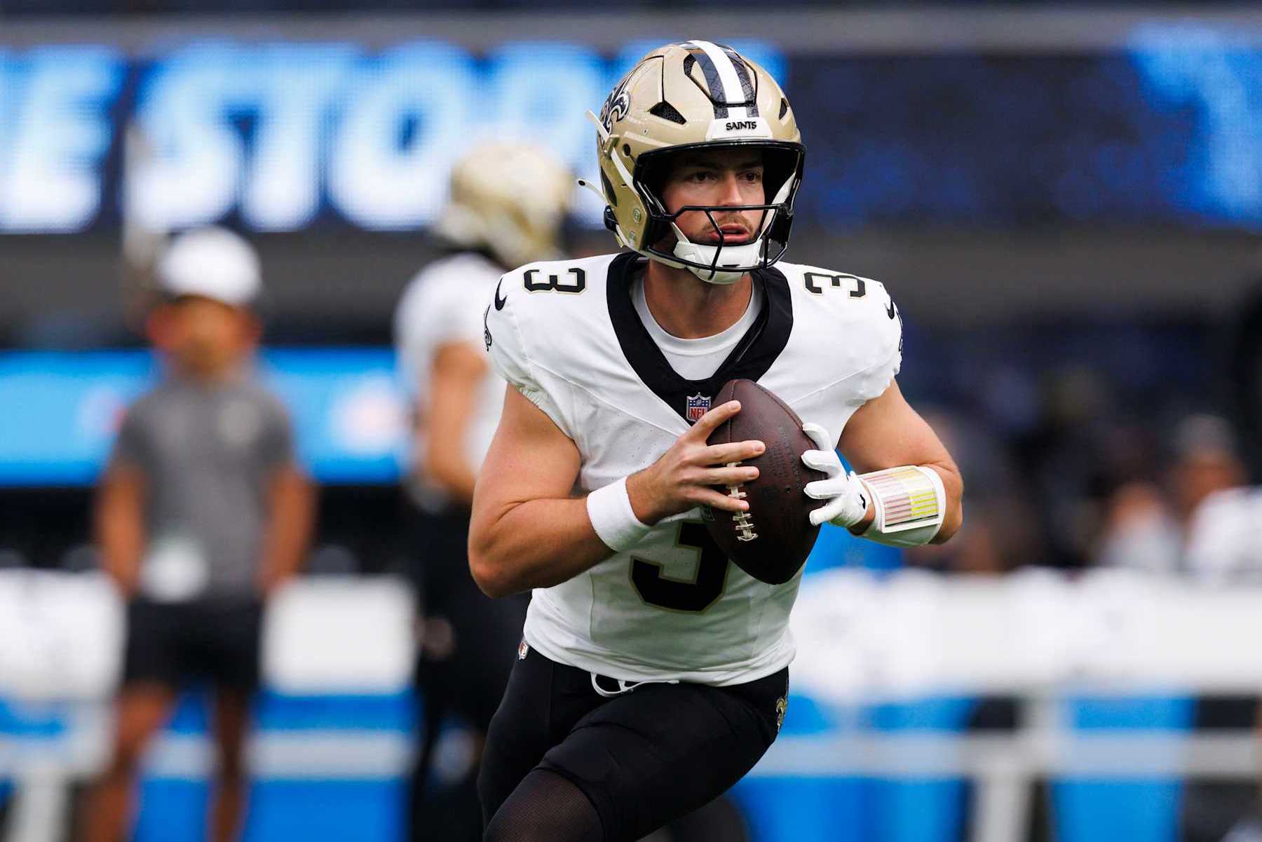 INGLEWOOD, CALIFORNIA - OCTOBER 27: Jake Haener #3 of the New Orleans Saints rolls out to pass before a game against the Los Angeles Chargers at SoFi Stadium on October 27, 2024 in Inglewood, California. (Photo by Ric Tapia/Getty Images)