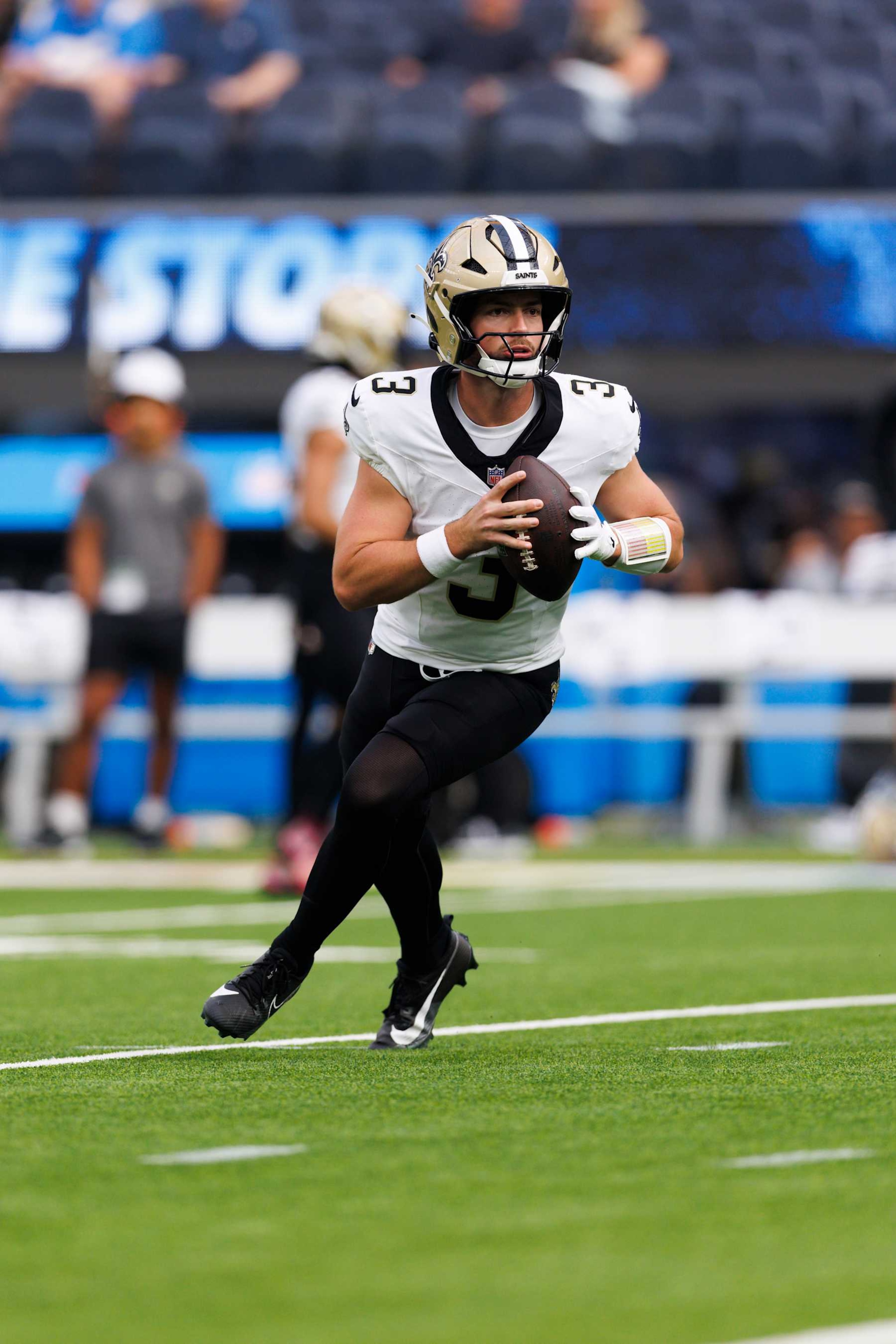 INGLEWOOD, CALIFORNIA - OCTOBER 27: Jake Haener #3 of the New Orleans Saints rolls out to pass before a game against the Los Angeles Chargers at SoFi Stadium on October 27, 2024 in Inglewood, California. (Photo by Ric Tapia/Getty Images)