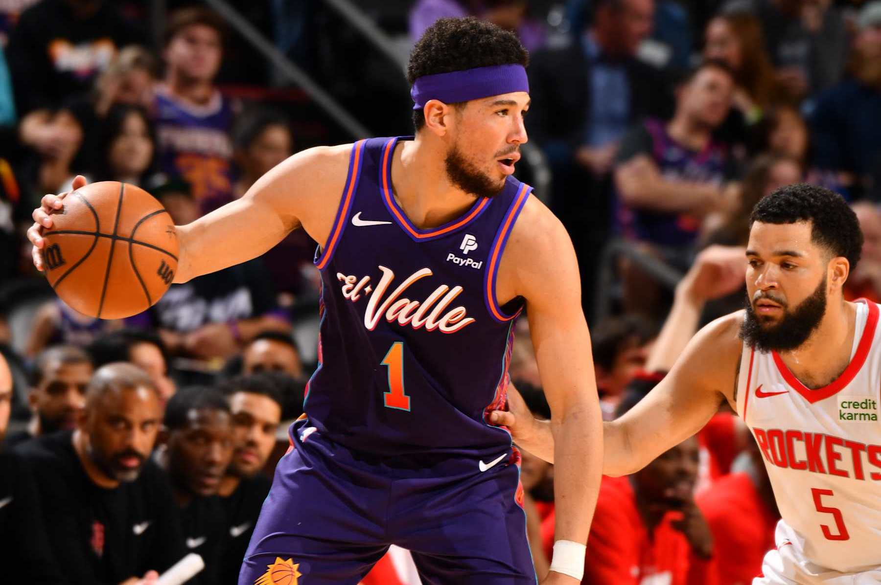 PHOENIX, AZ - FEBRUARY 29: Devin Booker #1 of the Phoenix Suns handles the ball against Fred VanVleet #5 of the Houston Rockets during the game on February 29, 2024 at Footprint Center in Phoenix, Arizona. NOTE TO USER: User expressly acknowledges and agrees that, by downloading and or using this photograph, user is consenting to the terms and conditions of the Getty Images License Agreement. Mandatory Copyright Notice: Copyright 2024 NBAE (Photo by Barry Gossage/NBAE via Getty Images)