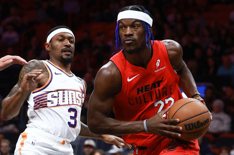 MIAMI, FLORIDA - DECEMBER 07: Jimmy Butler #22 of the Miami Heat drives around Bradley Beal #3 of the Phoenix Suns during the first half at Kaseya Center on December 07, 2024 in Miami, Florida. NOTE TO USER: User expressly acknowledges and agrees that, by downloading and or using this Photograph, user is consenting to the terms and conditions of the Getty Images License Agreement. (Photo by Carmen Mandato/Getty Images)