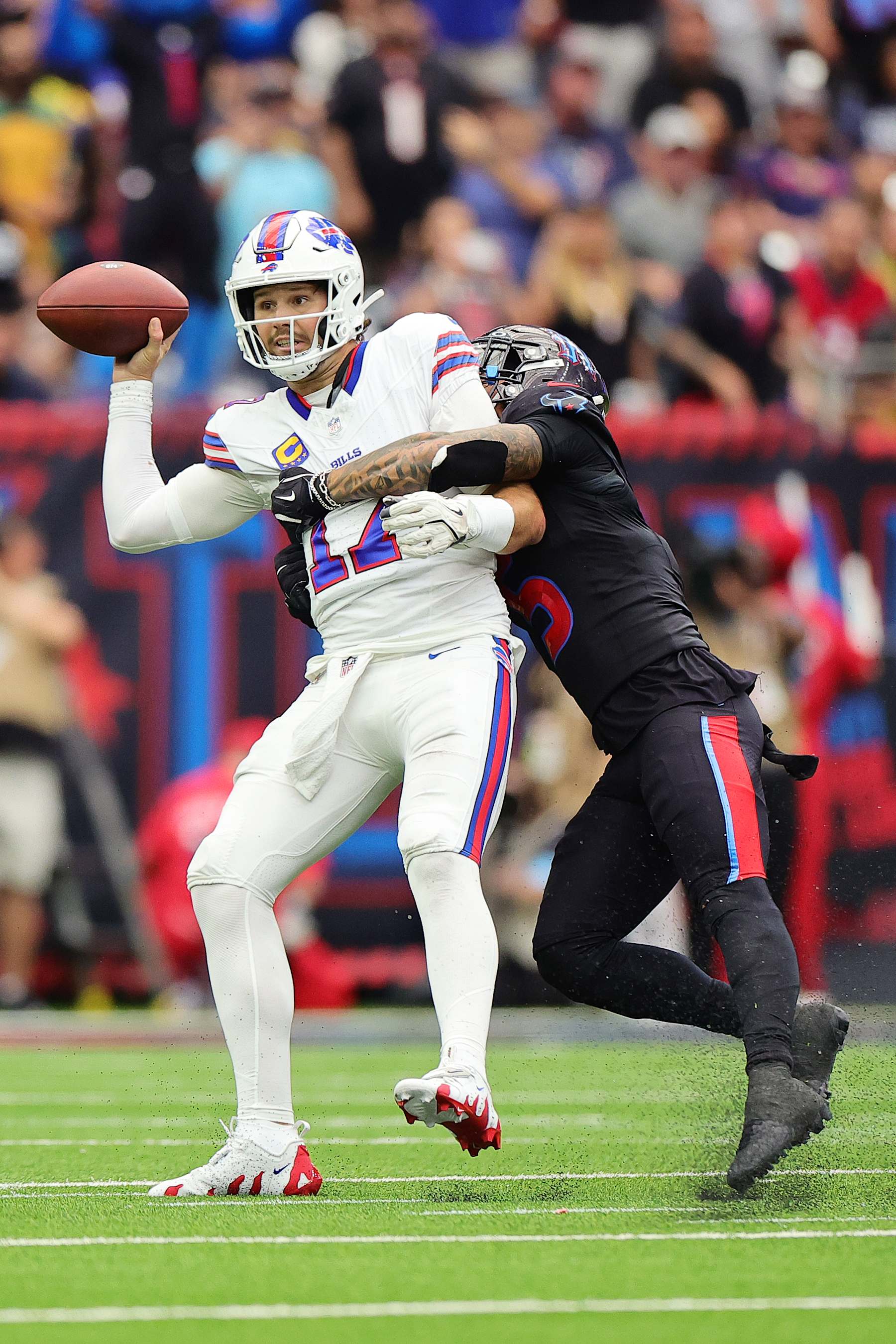 HOUSTON, TEXAS - OCTOBER 06: Jalen Pitre #5 of the Houston Texans sacks Josh Allen #17 of the Buffalo Bills during the fourth quarter at NRG Stadium on October 06, 2024 in Houston, Texas. (Photo by Alex Slitz/Getty Images)