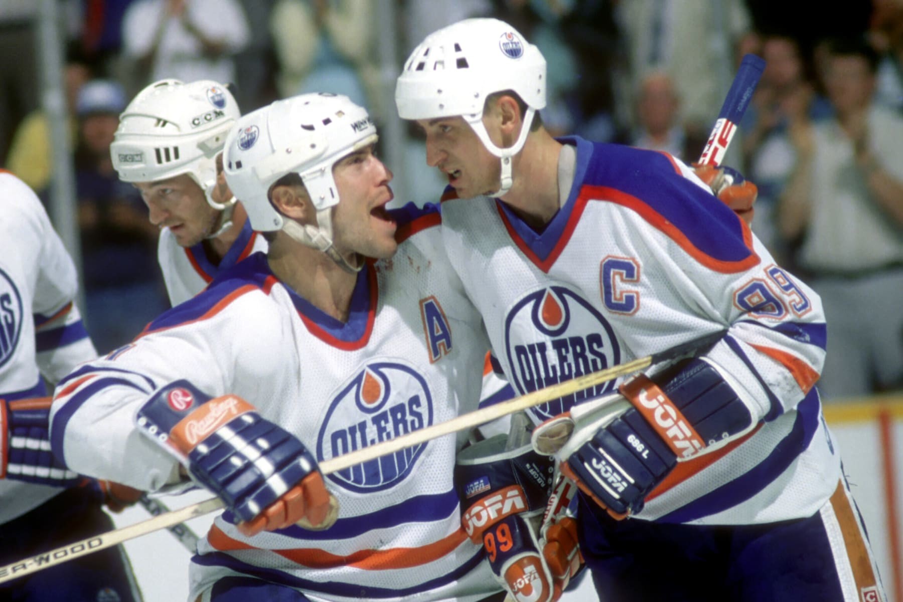 EDMONTON, AB - MAY, 1988:  Mark Messier #11 of the Edmonton Oilers celebrates with his teammate Wayne Gretzky #99 during the 1988 Stanley Cup Finals against the Boston Bruins in May, 1988 at the Northlands Coliseum in Edmonton, Alberta, Canada.  (Photo by Bruce Bennett Studios via Getty Images Studios/Getty Images)
