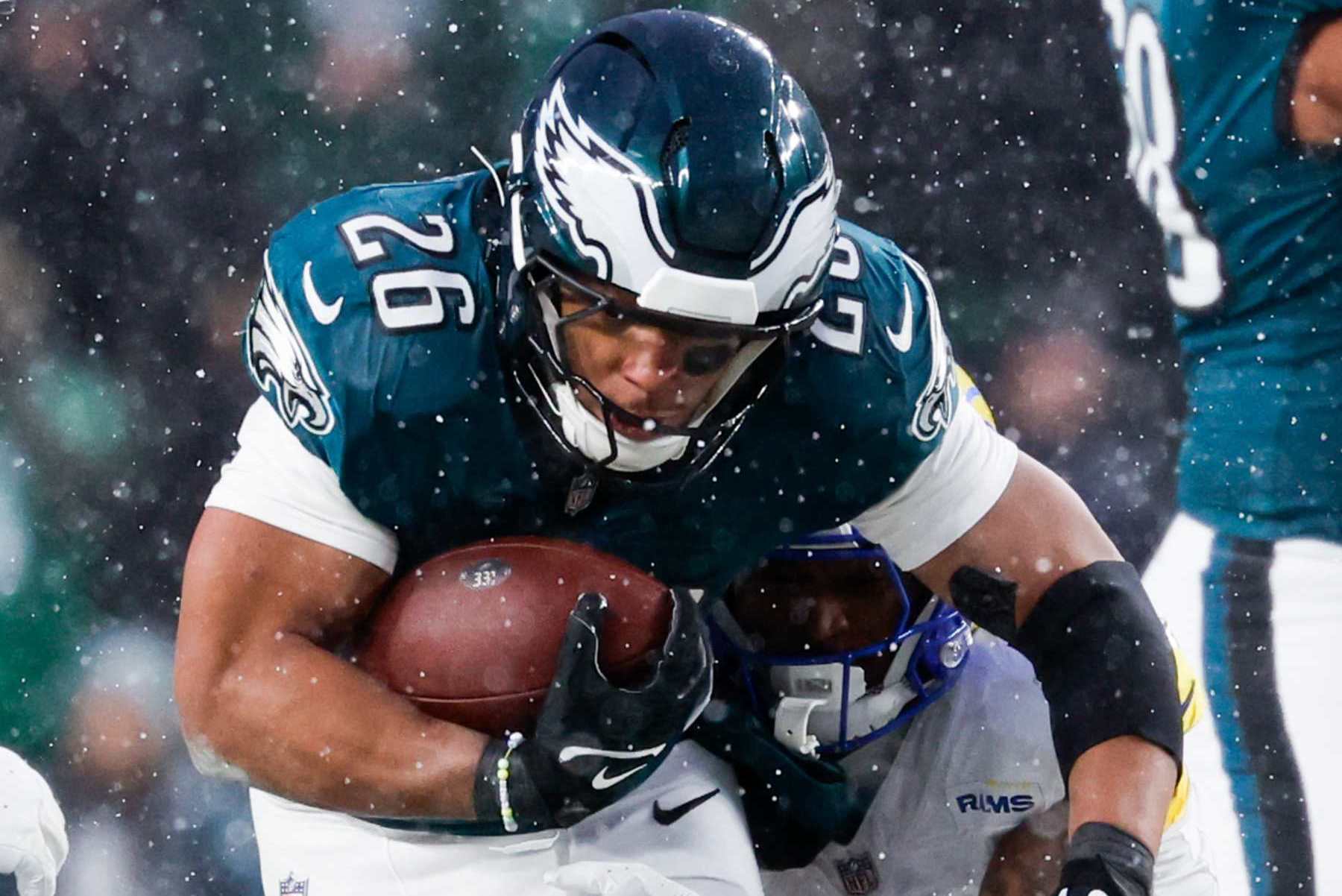 PHILADELPHIA, PA - JANUARY 19: Philadelphia Eagles running back Saquon Barkley, top, pushes through the Los Angeles Rams defense during the second quarter during an NFC divisional round at Lincoln Financial Field on Sunday, Jan. 19, 2025 in Philadelphia, PA. (Gina Ferazzi / Los Angeles Times via Getty Images)