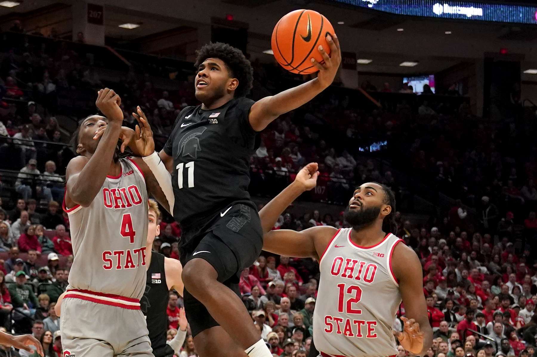 COLUMBUS, OH - JANUARY 03: Michigan State Spartans guard Jase Richardson (11) drives to the basket against Ohio State Buckeyes forward Aaron Bradshaw (4) during the first half of the game between the Ohio State Buckeyes and the Michigan State Spartans at Value City Arena in Columbus, Ohio on January 3, 2025. (Photo by Jason Mowry/Icon Sportswire via Getty Images)