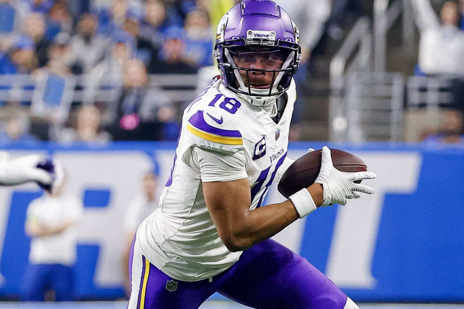 DETROIT, MICHIGAN - JANUARY 07: Justin Jefferson #18 of the Minnesota Vikings runs the ball up the field after a catch during the first half of a game against the Detroit Lions at Ford Field on January 07, 2024 in Detroit, Michigan. (Photo by Mike Mulholland/Getty Images)