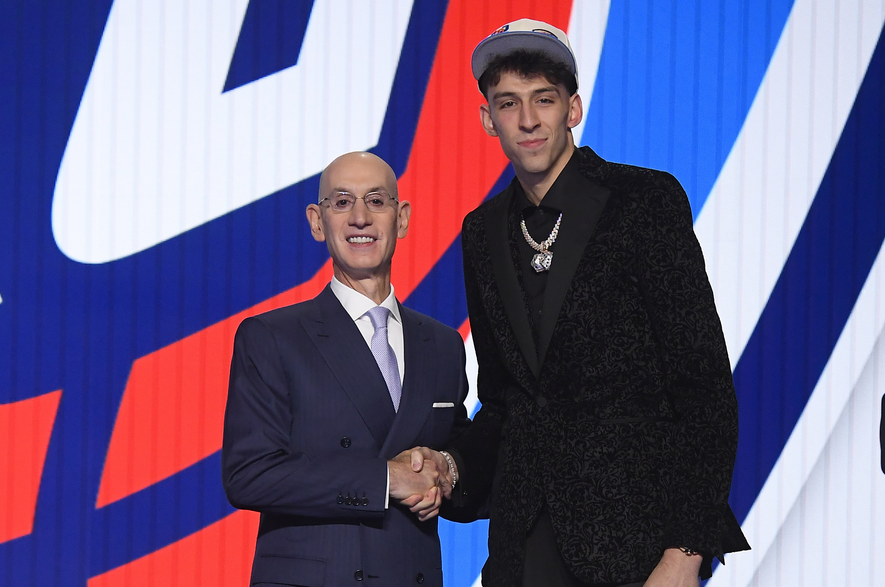 BROOKLYN, NY - JUNE 23: Chet Holmgren shakes hands with NBA Commissioner Adam Silver after being selected number two overall by the Oklahoma City Thunder during the 2022 NBA Draft on June 23, 2022 at Barclays Center in Brooklyn, New York. NOTE TO USER: User expressly acknowledges and agrees that, by downloading and or using this photograph, User is consenting to the terms and conditions of the Getty Images License Agreement. Mandatory Copyright Notice: Copyright 2022 NBAE (Photo by Brian Babineau/NBAE via Getty Images) BROOKLYN, NY - JUNE 23: Chet Holmgren shakes hands with NBA Commissioner Adam Silver after being selected number two overall by the Oklahoma City Thunder during the 2022 NBA Draft on June 23, 2022 at Barclays Center in Brooklyn, New York. NOTE TO USER: User expressly acknowledges and agrees that, by downloading and or using this photograph, User is consenting to the terms and conditions of the Getty Images License Agreement. Mandatory Copyright Notice: Copyright 2022 NBAE (Photo by Brian Babineau/NBAE via Getty Images)