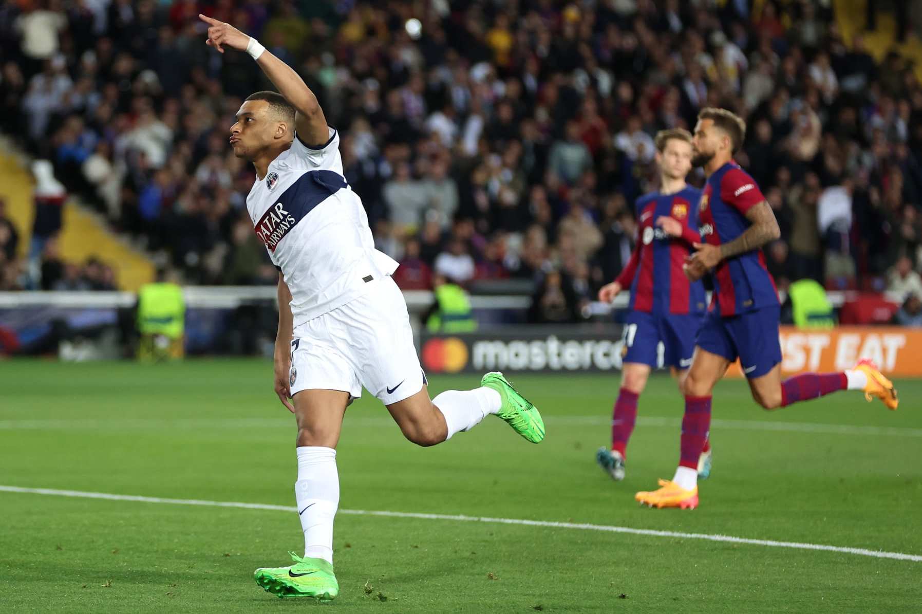 BARCELONA, SPAIN - APRIL 16: Kylian Mbappe of Paris Saint-Germain celebrates scoring his team's third goal from a penalty kick during the UEFA Champions League quarter-final second leg match between FC Barcelona and Paris Saint-Germain at Estadi Olimpic Lluis Companys on April 16, 2024 in Barcelona, Spain. (Photo by Clive Brunskill/Getty Images)