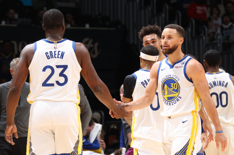 WASHINGTON, DC -  FEBRUARY 27: Draymond Green #23 of the Golden State Warriors high fives Stephen Curry #30 during the game against the Washington Wizards on February 27, 2024 at Capital One Arena in Washington, DC. NOTE TO USER: User expressly acknowledges and agrees that, by downloading and or using this Photograph, user is consenting to the terms and conditions of the Getty Images License Agreement. Mandatory Copyright Notice: Copyright 2024 NBAE (Photo by Stephen Gosling/NBAE via Getty Images)