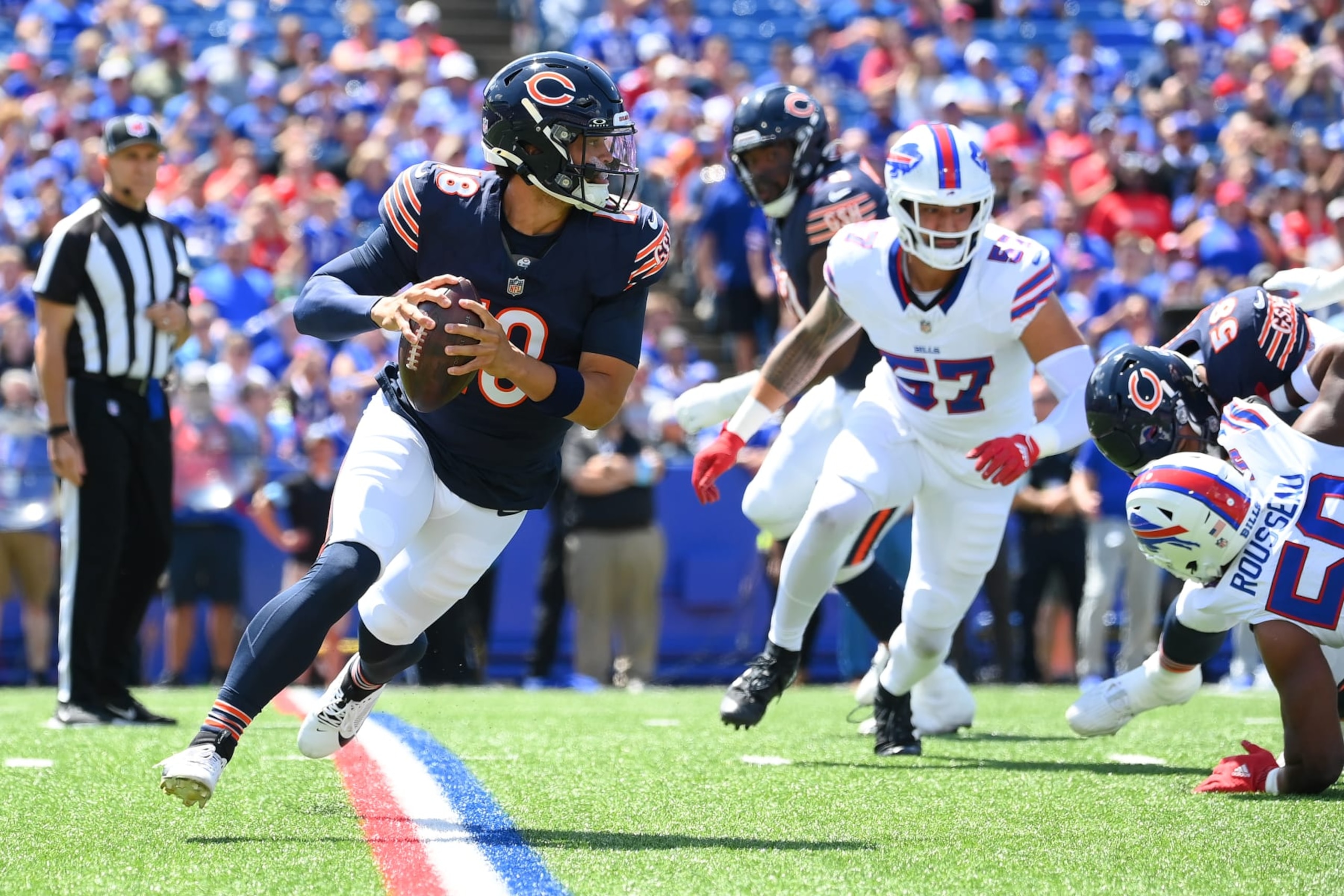 Chicago Bears rookie quarterback Caleb Williams rolls to his right during a preseason contest against the Buffalo Bills.