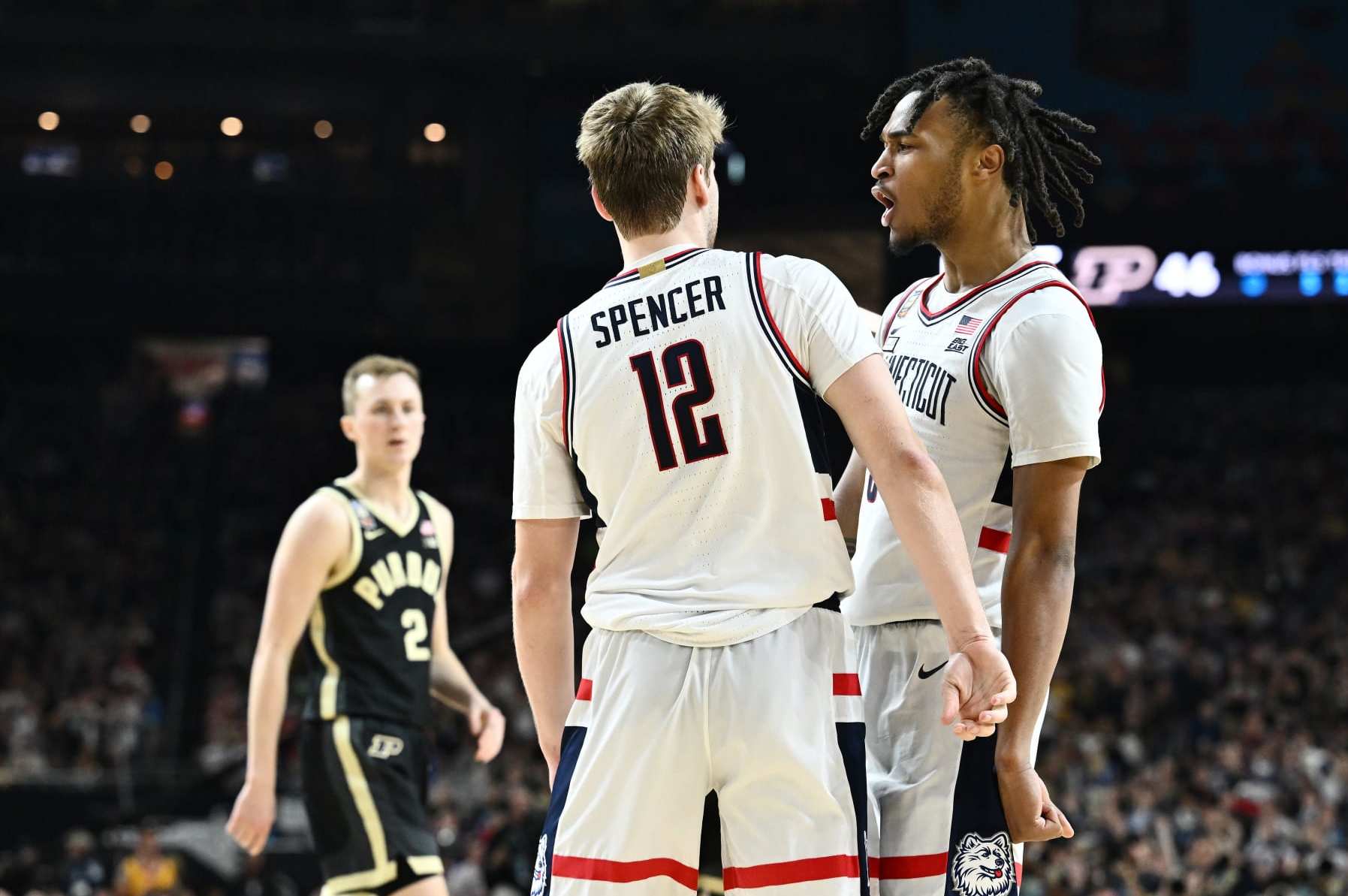 GLENDALE, ARIZONA - APRIL 08: Cam Spencer #12 of the Connecticut Huskies and Myles Colvin #5 of the Purdue Boilermakers react during the second half in the NCAA Men's Basketball Tournament National Championship game at State Farm Stadium on April 08, 2024 in Glendale, Arizona. (Photo by Brett Wilhelm/NCAA Photos via Getty Images)
