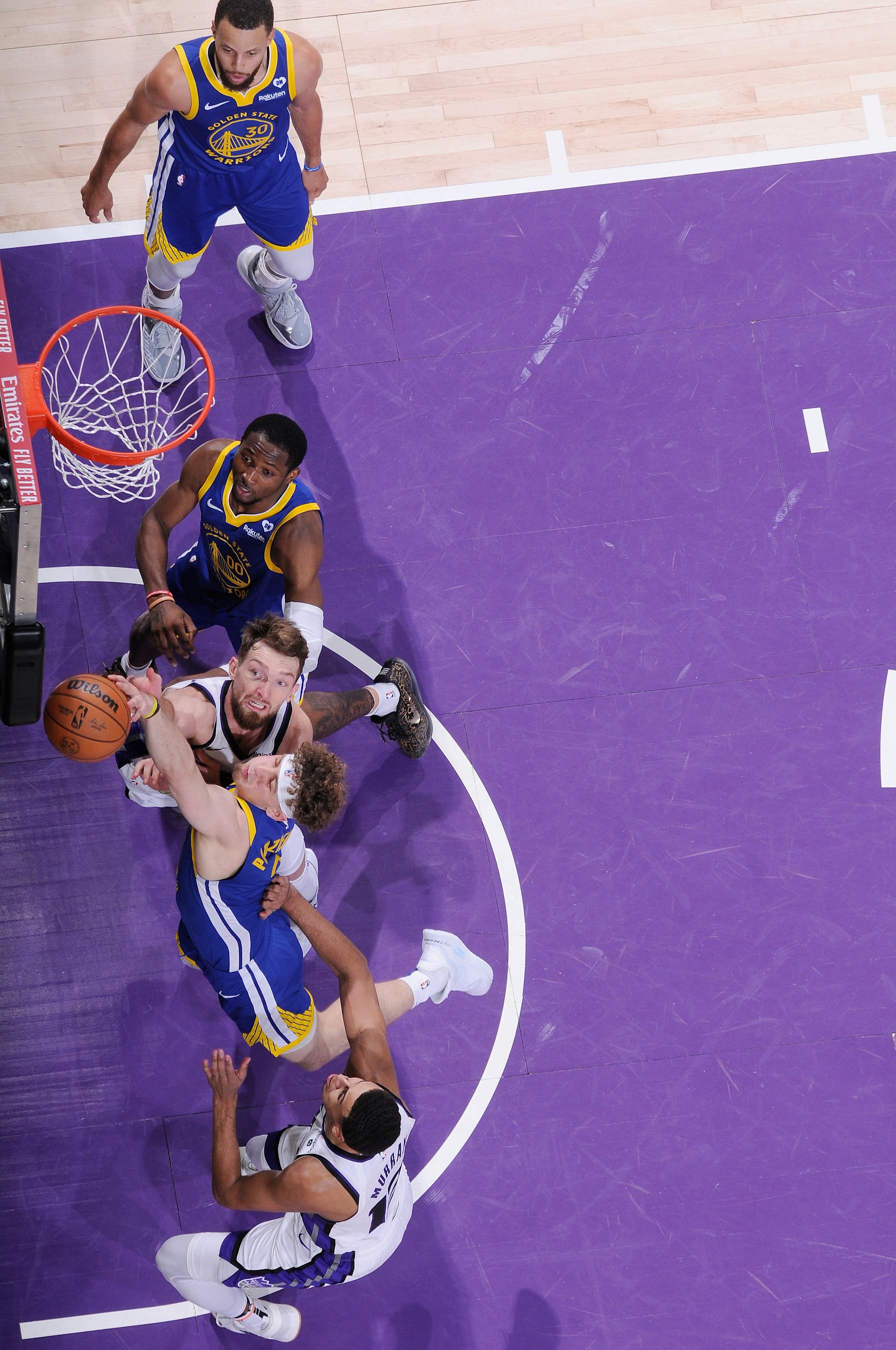 SACRAMENTO, CA - APRIL 16: Brandin Podziemski #2 of the Golden State Warriors and Domantas Sabonis #10 of the Sacramento Kings fight for the rebound during the game during the 2024 Play-In Tournament on April 16, 2024 at Golden 1 Center in Sacramento, California. NOTE TO USER: User expressly acknowledges and agrees that, by downloading and or using this photograph, User is consenting to the terms and conditions of the Getty Images Agreement. Mandatory Copyright Notice: Copyright 2024 NBAE (Photo by Rocky Widner/NBAE via Getty Images)