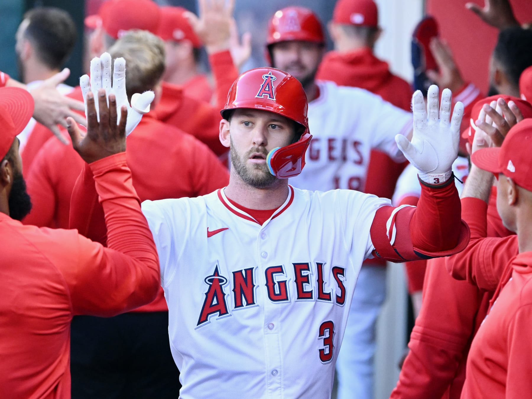 ANAHEIM, CA - JUNE 17: Los Angeles Angels left fielder Taylor Ward (3) is greeted in the dugout after hitting a sacrifice fly scoring a run in the third inning of an MLB baseball game against the Milwaukee Brewers played on June 17, 2024 at Angel Stadium in Anaheim, CA. (Photo by John Cordes/Icon Sportswire via Getty Images)