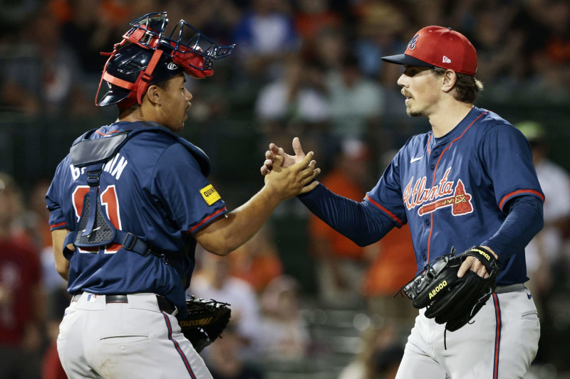 SARASOTA, FLORIDA - MARCH 13: Parker Dunshee #93 of the Atlanta Braves is congratulated by teammate Drake Baldwin #81 after the final out of a spring training game against the Baltimore Orioles at Ed Smith Stadium on March 13, 2024 in Sarasota, Florida. The Braves defeated the Orioles 7-5. (Photo by Christopher Pasatieri/Getty Images)