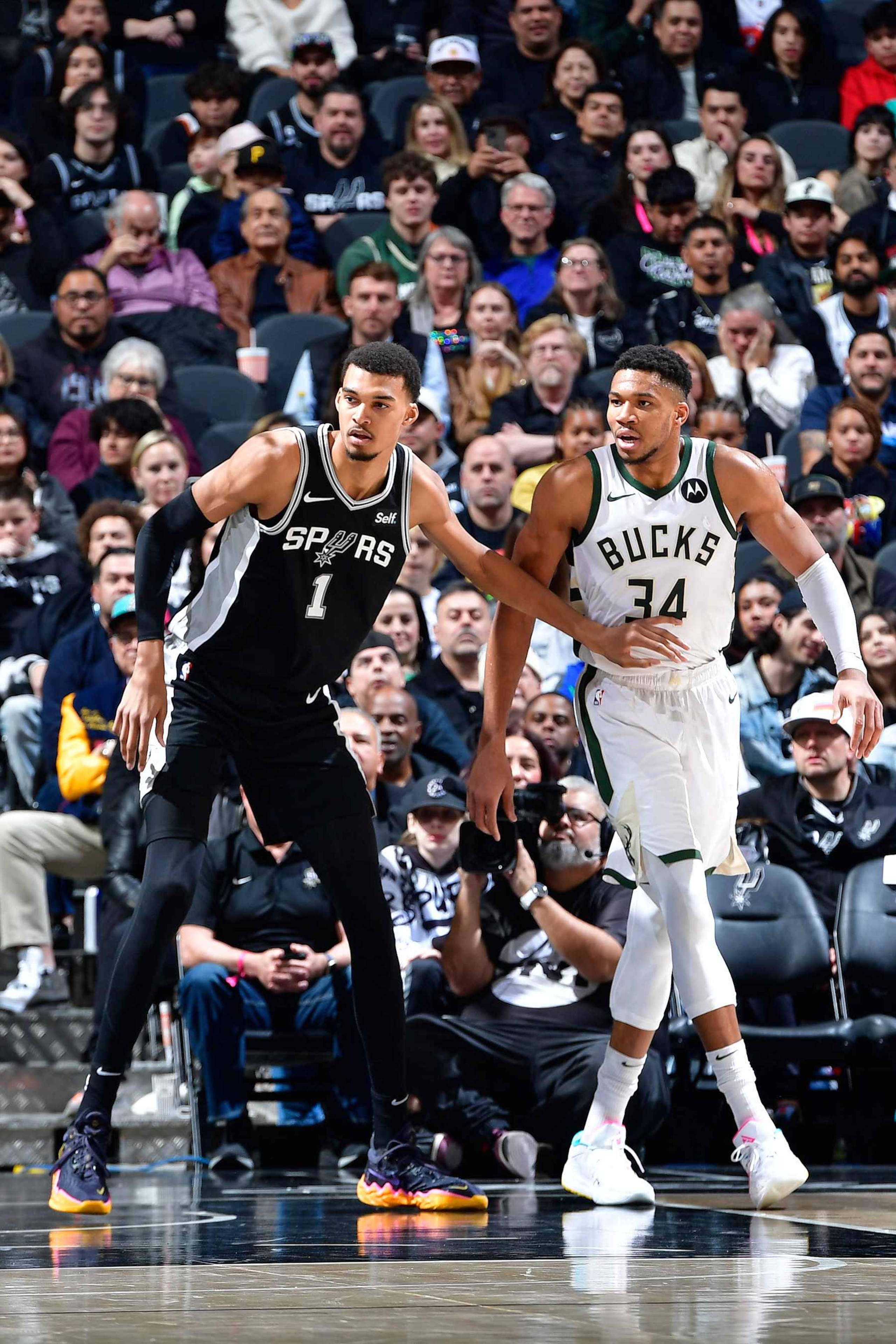 SAN ANTONIO, TX - JANUARY 4: Victor Wembanyama #1 of the San Antonio Spurs and Giannis Antetokounmpo #34 of the Milwaukee Bucks looks on during the game on January 4, 2024 at the Frost Bank Center in San Antonio, Texas. NOTE TO USER: User expressly acknowledges and agrees that, by downloading and or using this photograph, User is consenting to the terms and conditions of the Getty Images License Agreement. Mandatory Copyright Notice: Copyright 2024 NBAE (Photo by Logan Riely/NBAE via Getty Images) SAN ANTONIO, TX - JANUARY 4: Victor Wembanyama #1 of the San Antonio Spurs and Giannis Antetokounmpo #34 of the Milwaukee Bucks looks on during the game on January 4, 2024 at the Frost Bank Center in San Antonio, Texas. NOTE TO USER: User expressly acknowledges and agrees that, by downloading and or using this photograph, User is consenting to the terms and conditions of the Getty Images License Agreement. Mandatory Copyright Notice: Copyright 2024 NBAE (Photo by Logan Riely/NBAE via Getty Images)