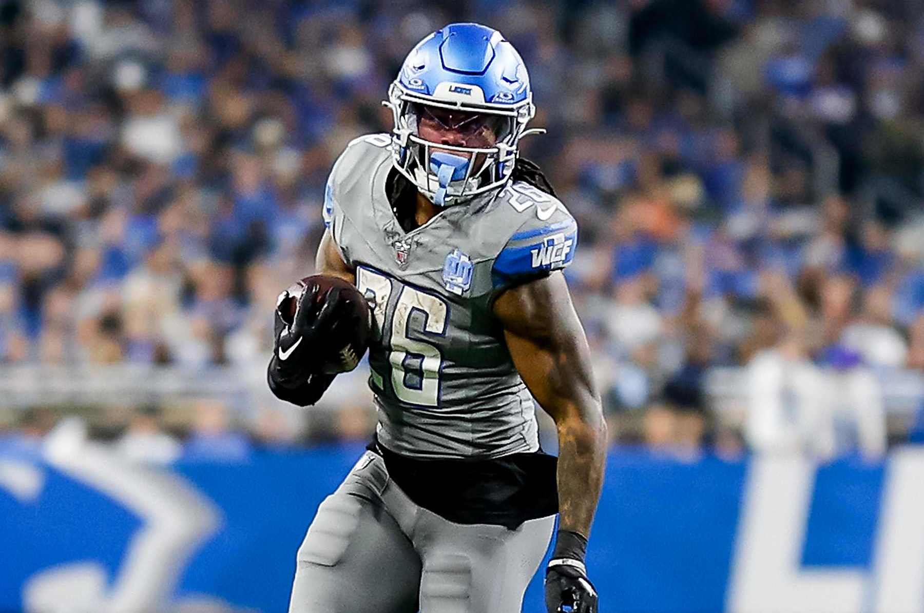 DETROIT, MICHIGAN - JANUARY 07: Jahmyr Gibbs #26 of the Detroit Lions runs the ball up the field in the second half of a game against the Minnesota Vikings at Ford Field on January 07, 2024 in Detroit, Michigan. (Photo by Mike Mulholland/Getty Images)