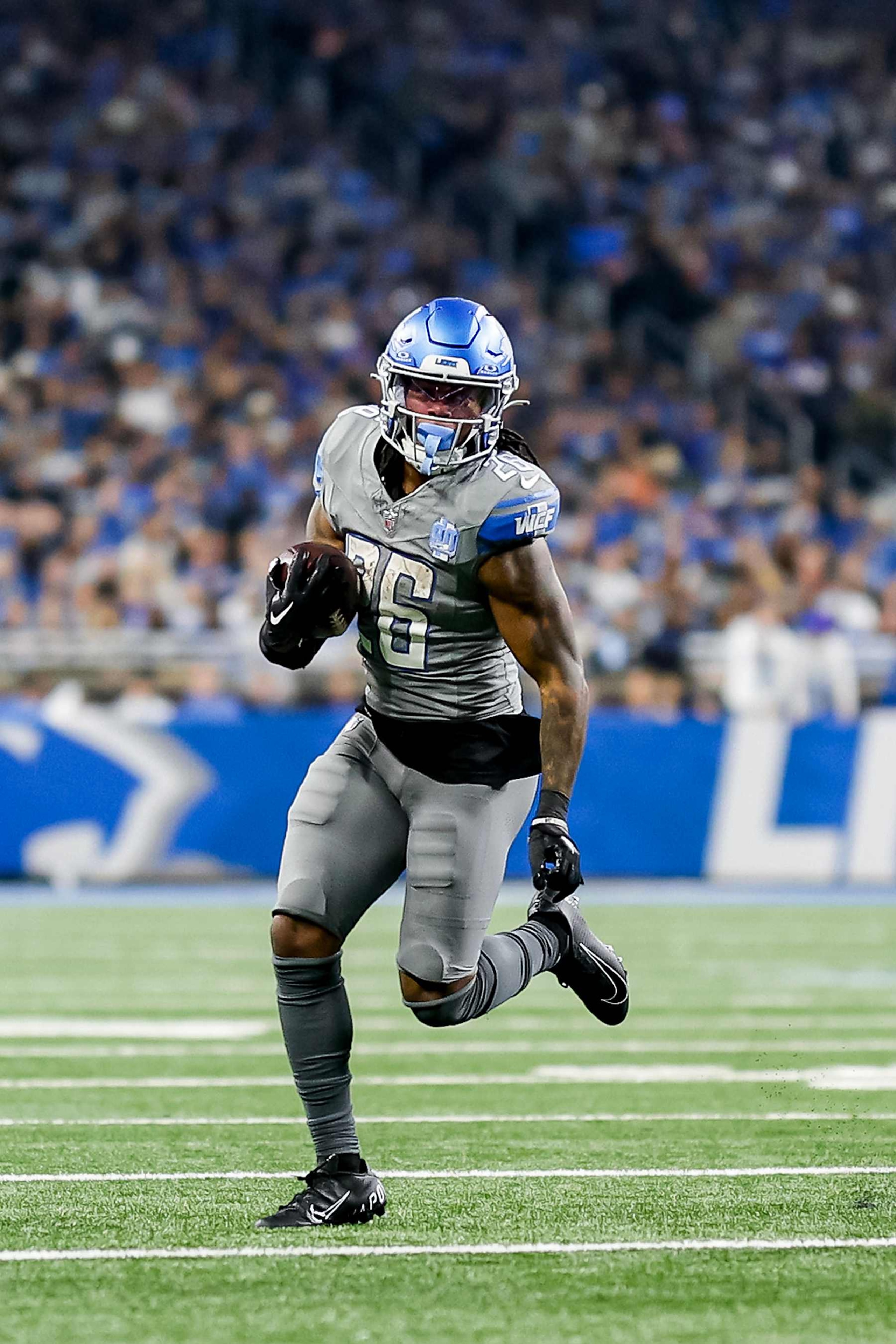 DETROIT, MICHIGAN - JANUARY 07: Jahmyr Gibbs #26 of the Detroit Lions runs the ball up the field in the second half of a game against the Minnesota Vikings at Ford Field on January 07, 2024 in Detroit, Michigan. (Photo by Mike Mulholland/Getty Images)