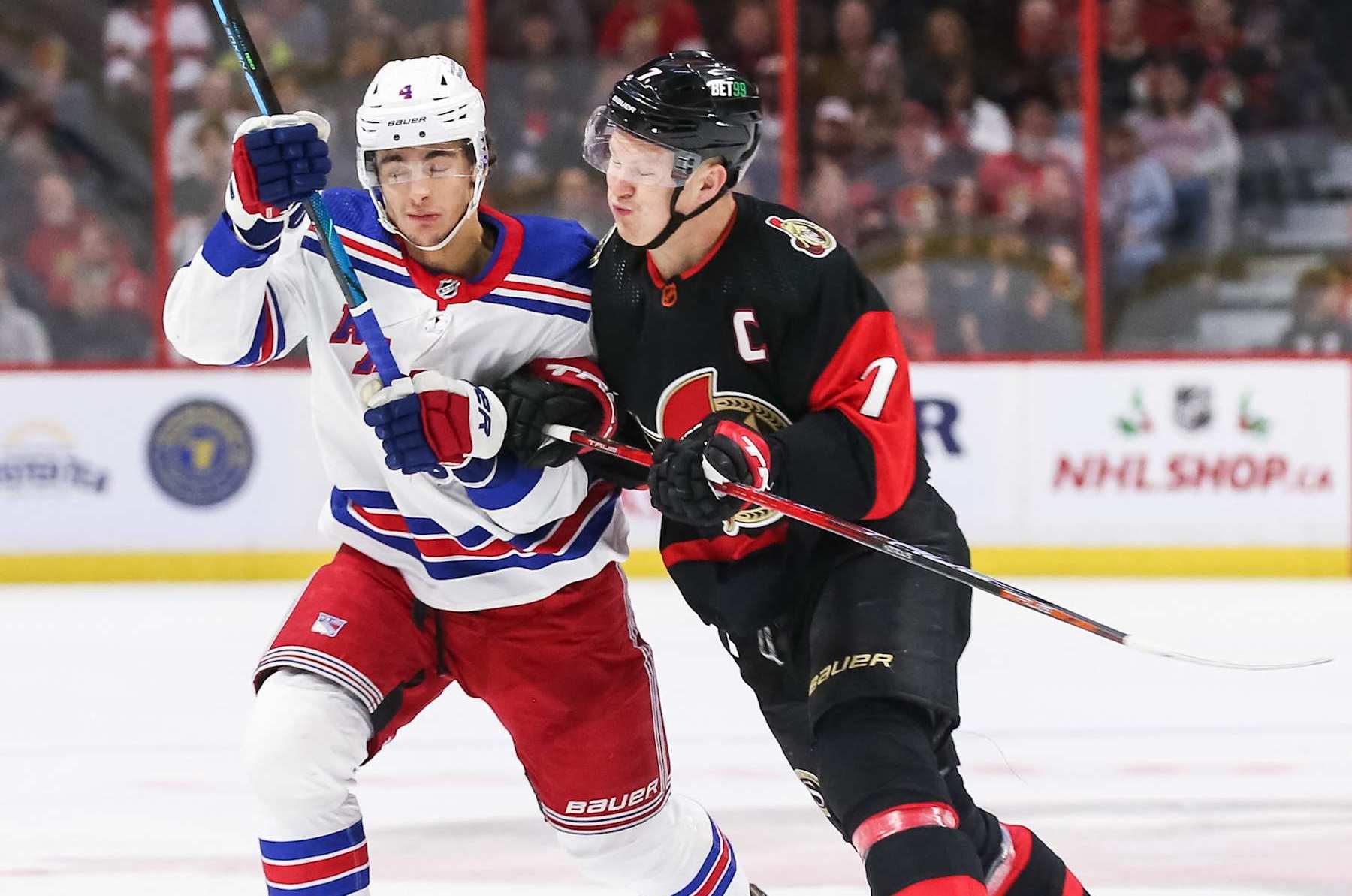 OTTAWA, ONTARIO - NOVEMBER 30: Brady Tkachuk #7 of the Ottawa Senators bodychecks Braden Schneider #4 of the New York Rangers during the first period at Canadian Tire Centre on November 30, 2022 in Ottawa, Ontario, Canada. (Photo by Chris Tanouye/Freestyle Photo/Getty Images)