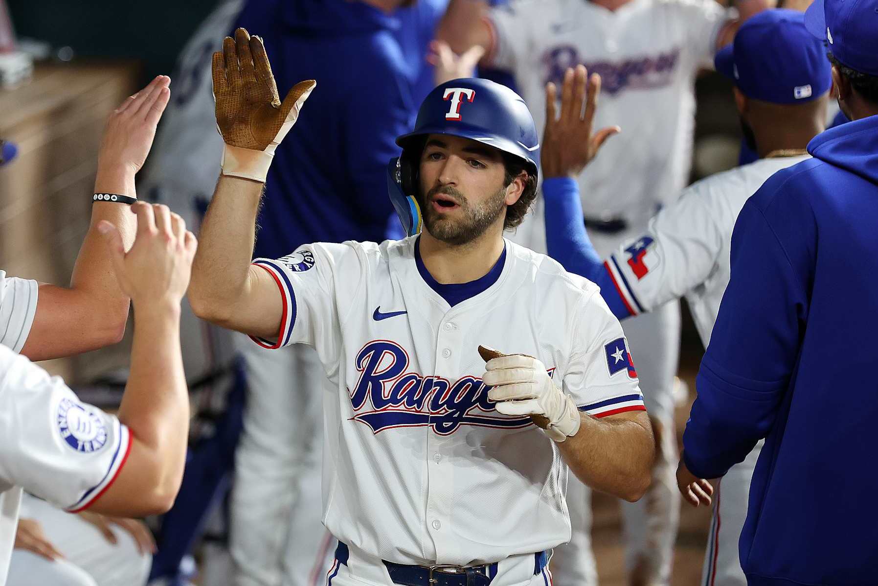 ARLINGTON, TEXAS - SEPTEMBER 21: Josh Smith #8 of the Texas Rangers celebrates in the dugout after a home run against the Seattle Mariners at Globe Life Field on September 21, 2024 in Arlington, Texas. (Photo by Richard Rodriguez/Getty Images)