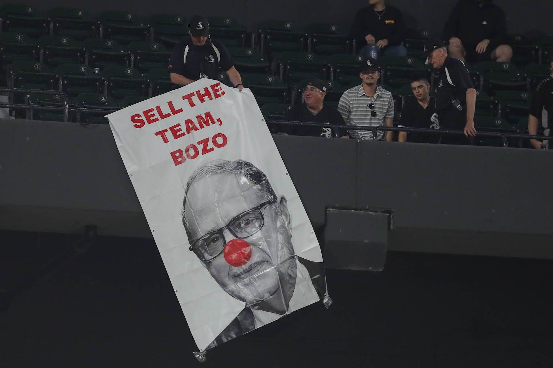 CHICAGO, IL - MAY 23: Security removes a sign that is hung from the upper deck of Chicago White Sox Chairperson Jerry Reinsdorf in the ninth inning during a game against the Baltimore Orioles and the Chicago White Sox on May 23, 2024 at Guaranteed Rate Field in Chicago, Illinois. (Photo by Melissa Tamez/Icon Sportswire via Getty Images)
