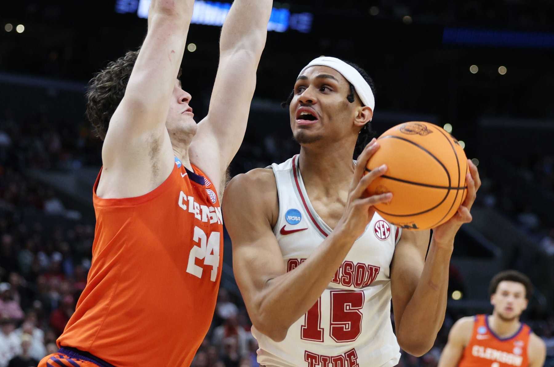 LOS ANGELES, CALIFORNIA - MARCH 30: Jarin Stevenson #15 of the Alabama Crimson Tide handles the ball against PJ Hall #24 of the Clemson Tigers during the first half in the Elite 8 round of the NCAA Men's Basketball Tournament at Crypto.com Arena on March 30, 2024 in Los Angeles, California. (Photo by Harry How/Getty Images)