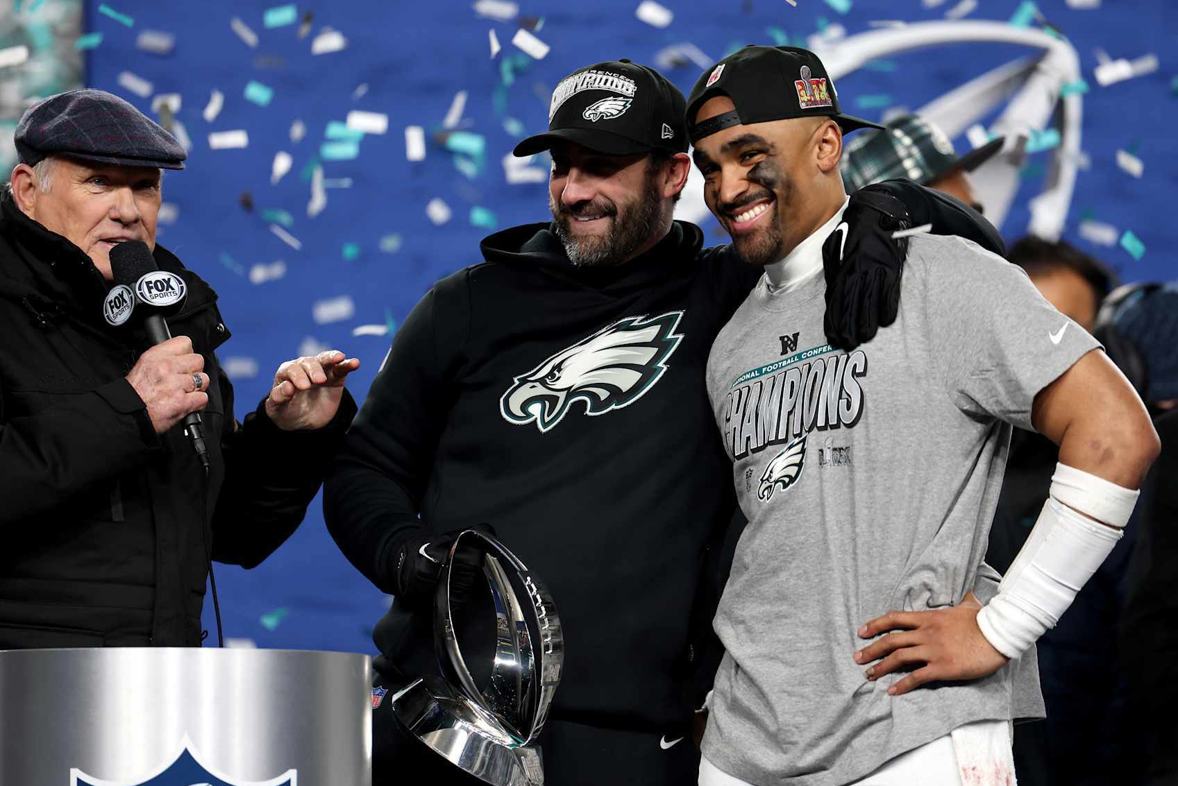 PHILADELPHIA, PENNSYLVANIA - JANUARY 26: Head coach Nick Sirianni and Jalen Hurts #1 of the Philadelphia Eagles smile during the trophy ceremony after defeating the Washington Commanders 55-23 to win the NFC Championship Game at Lincoln Financial Field on January 26, 2025 in Philadelphia, Pennsylvania.  (Photo by Emilee Chinn/Getty Images)
