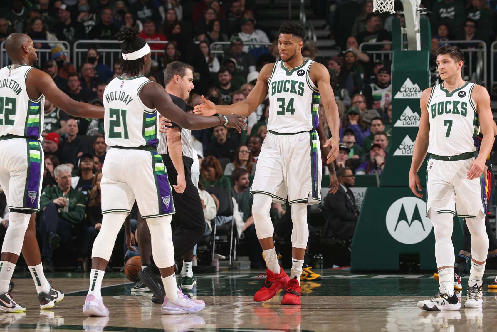 MILWAUKEE, WI - MARCH 9: Giannis Antetokounmpo #34 of the Milwaukee Bucks high fives Jrue Holiday #21 of the Milwaukee Bucks and Khris Middleton #22 of the Milwaukee Bucks during the game against the Atlanta Hawks on March 9, 2022 at the Fiserv Forum Center in Milwaukee, Wisconsin. NOTE TO USER: User expressly acknowledges and agrees that, by downloading and or using this Photograph, user is consenting to the terms and conditions of the Getty Images License Agreement. Mandatory Copyright Notice: Copyright 2022 NBAE (Photo by Gary Dineen/NBAE via Getty Images). MILWAUKEE, WI - MARCH 9: Giannis Antetokounmpo #34 of the Milwaukee Bucks high fives Jrue Holiday #21 of the Milwaukee Bucks and Khris Middleton #22 of the Milwaukee Bucks during the game against the Atlanta Hawks on March 9, 2022 at the Fiserv Forum Center in Milwaukee, Wisconsin. NOTE TO USER: User expressly acknowledges and agrees that, by downloading and or using this Photograph, user is consenting to the terms and conditions of the Getty Images License Agreement. Mandatory Copyright Notice: Copyright 2022 NBAE (Photo by Gary Dineen/NBAE via Getty Images).