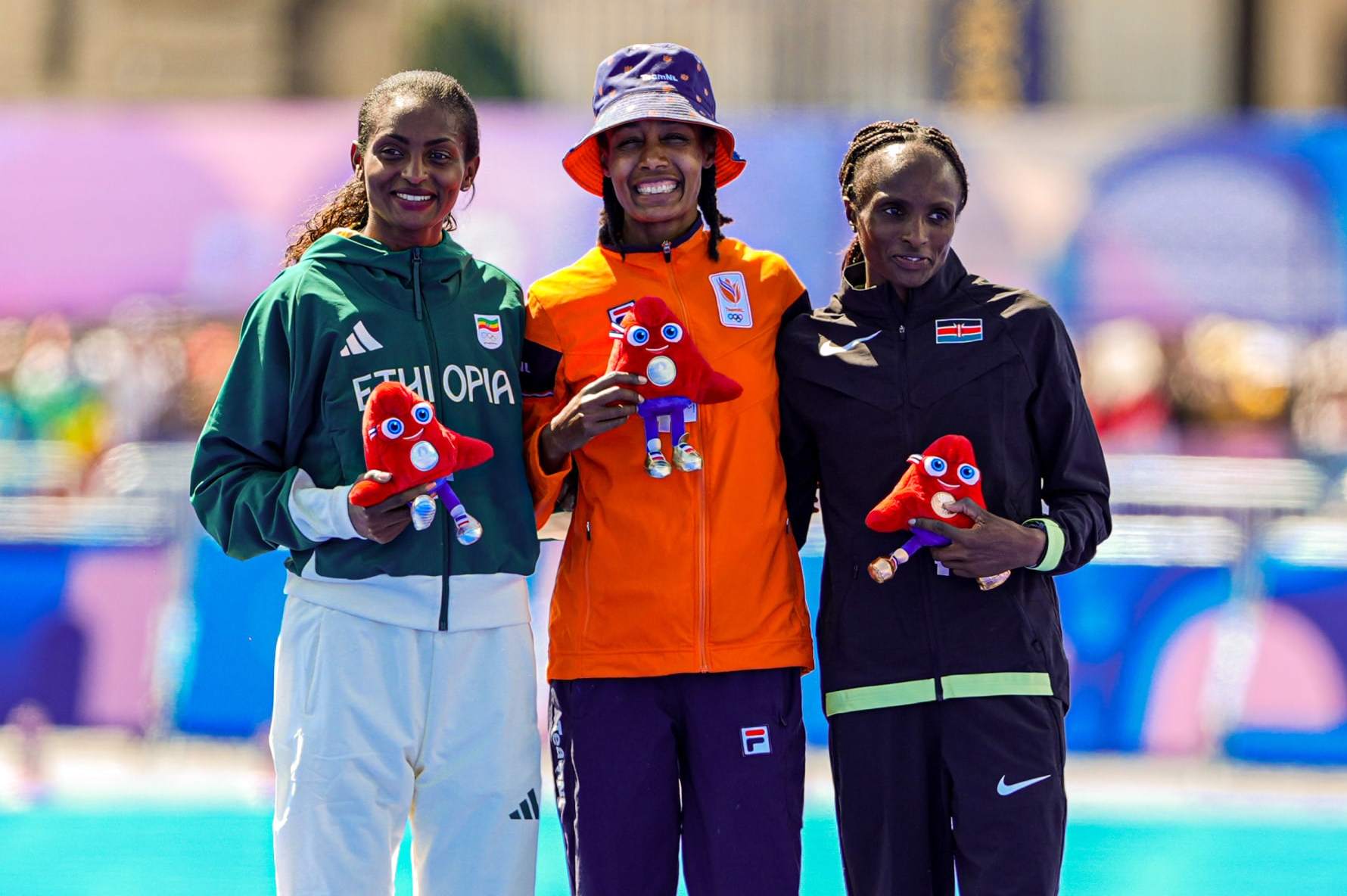 PARIS, FRANCE - AUGUST 11: Tigist Assefa of Ethiopia, Sifan Hassan of the Netherlands, Hellen Obiri of Kenya celebrate competing in the Women's Marathon - Winning ceremony during Day 16 of Athletics Marathon - Olympic Games Paris 2024 at Esplanade Des Invalides on August 11, 2024 in Paris, France. (Photo by Joris Verwijst/BSR Agency/Getty Images)