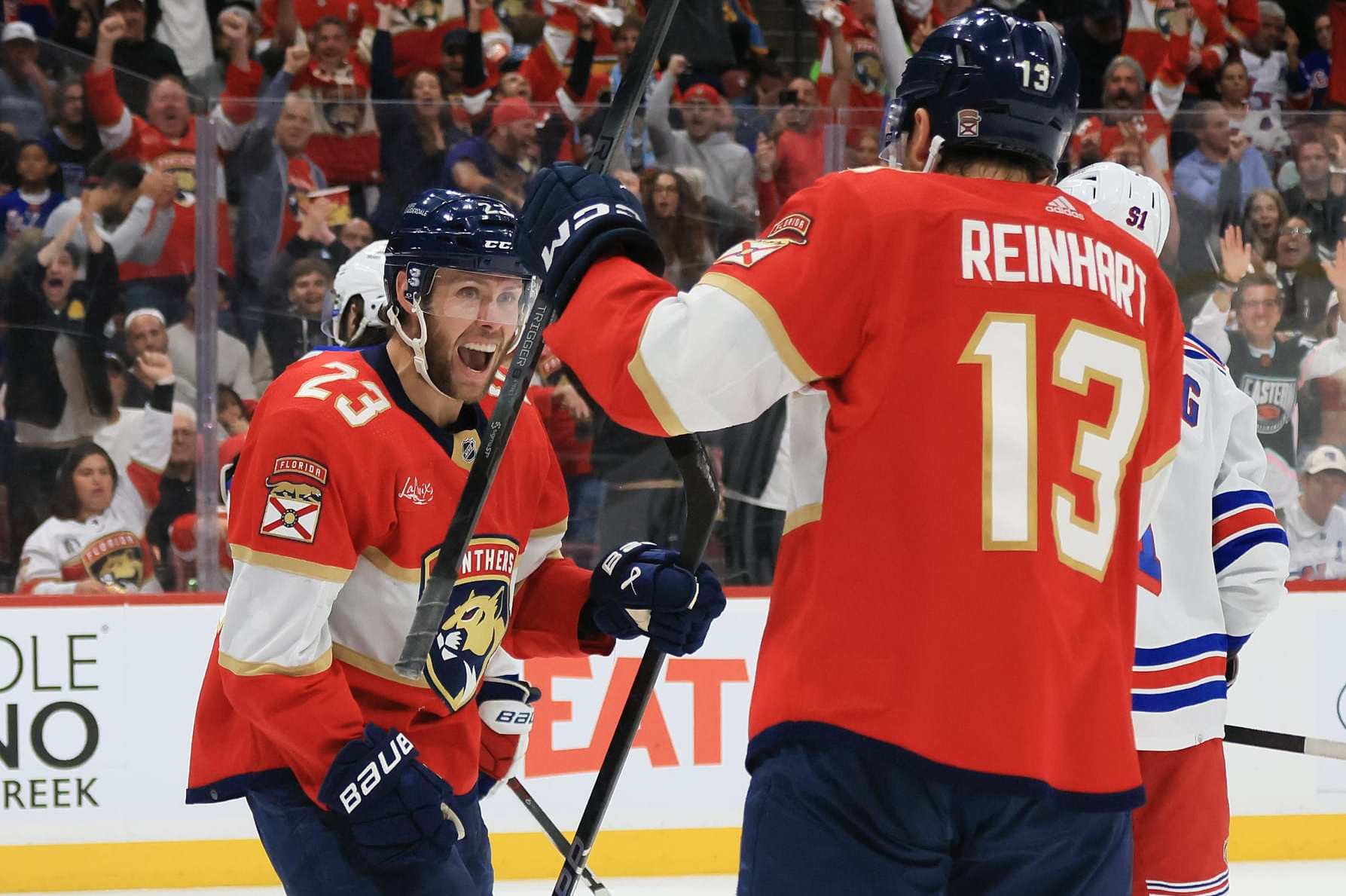 SUNRISE, FLORIDA - MAY 28: Carter Verhaeghe #23 of the Florida Panthers congratulated by Sam Reinhart #13 of the Florida Panthers after scoring a goal against the New York Rangers during the second period in Game Four of the Eastern Conference Final of the 2024 Stanley Cup Playoffs at Amerant Bank Arena on May 28, 2024 in Sunrise, Florida. (Photo by Bruce Bennett/Getty Images)