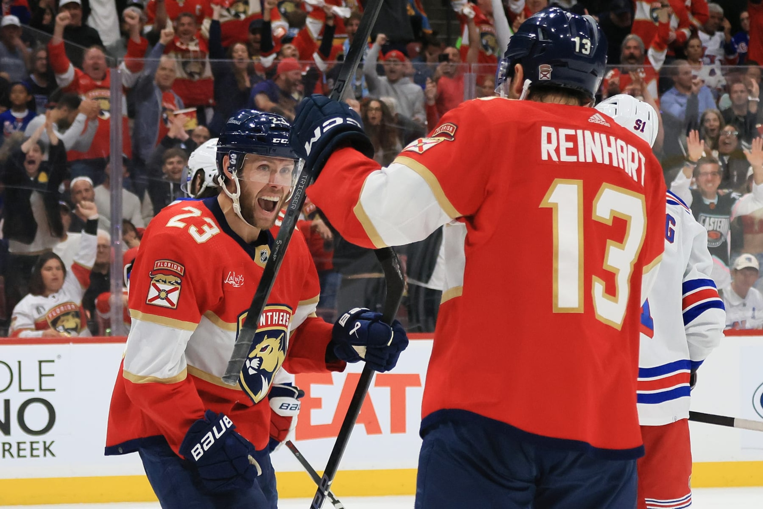 SUNRISE, FLORIDA - MAY 28:  Carter Verhaeghe #23 of the Florida Panthers congratulated by Sam Reinhart #13 of the Florida Panthers after scoring a goal against the New York Rangers during the second period in Game Four of the Eastern Conference Final of the 2024 Stanley Cup Playoffs at Amerant Bank Arena on May 28, 2024 in Sunrise, Florida.  (Photo by Bruce Bennett/Getty Images)