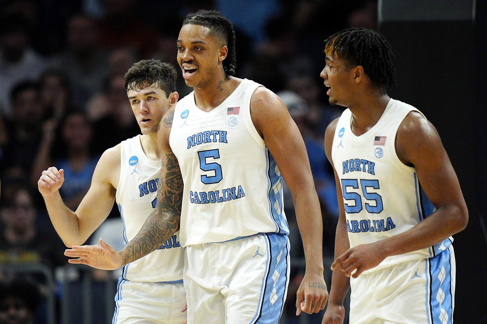 CHARLOTTE, NORTH CAROLINA - MARCH 23: Cormac Ryan #3, Armando Bacot #5 and Harrison Ingram #55 of the North Carolina Tar Heels react to a play during the first half against the Michigan State Spartans in the second round of the NCAA Men's Basketball Tournament at Spectrum Center on March 23, 2024 in Charlotte, North Carolina. (Photo by Jacob Kupferman/Getty Images)