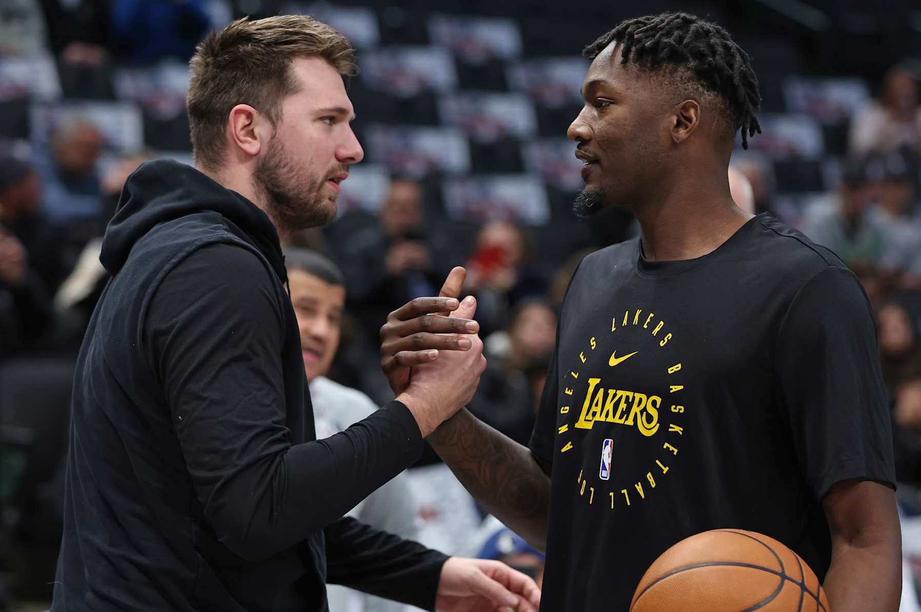 DALLAS, TX - JANUARY 7: Luka Doncic #77 of the Dallas Mavericks and Dorian Finney-Smith #17 of the Los Angeles Lakers high five before the game on January 7, 2025 at American Airlines Center in Dallas, Texas. NOTE TO USER: User expressly acknowledges and agrees that, by downloading and or using this photograph, User is consenting to the terms and conditions of the Getty Images License Agreement. Mandatory Copyright Notice: Copyright 2025 NBAE (Photo by Tim Heitman/NBAE via Getty Images)