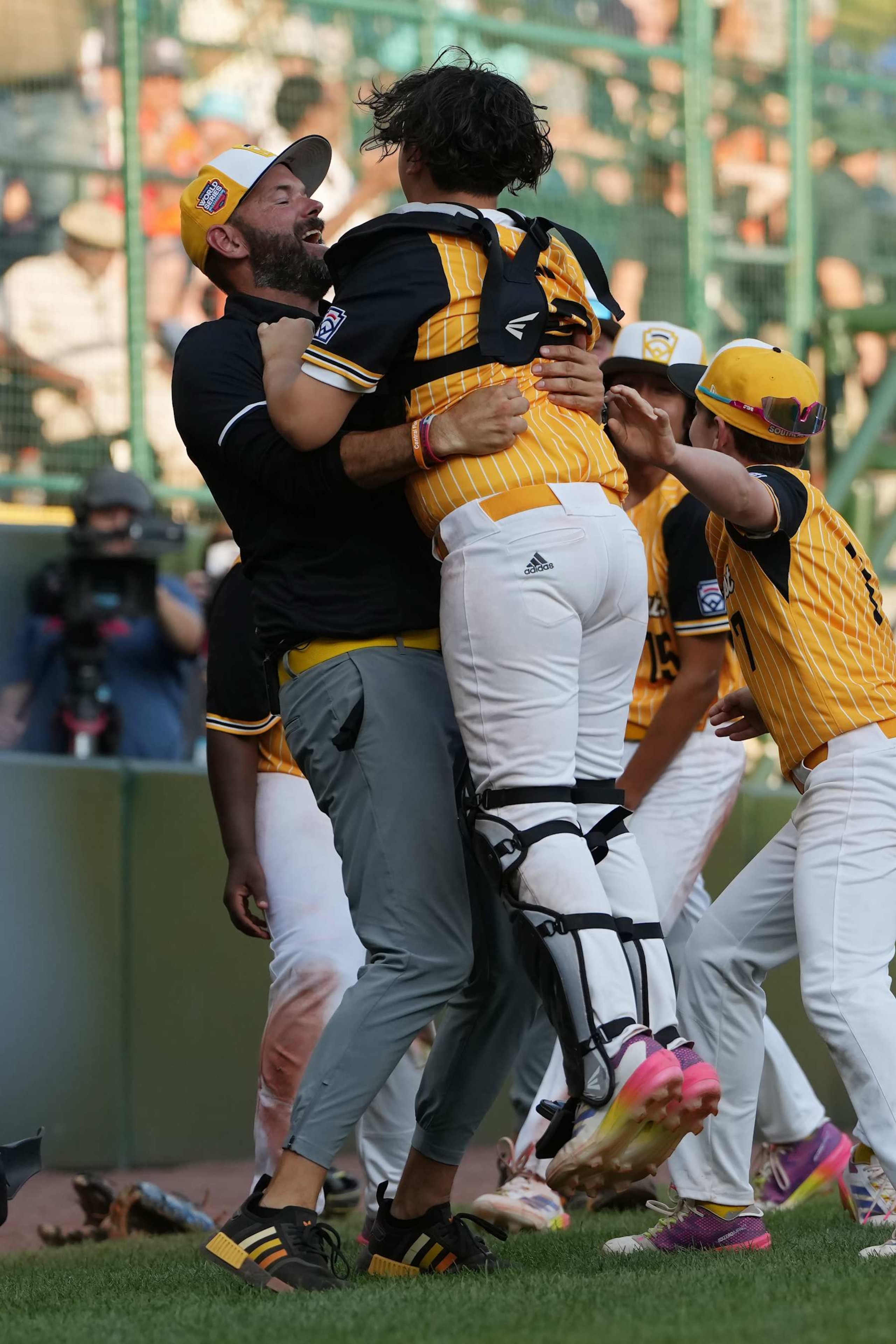 SOUTH WILLIAMSPORT, PENNSYLVANIA - AUGUST 24: Coach Kyle Bono and Landon Bono #19 of the Southeast Region team from Lake Mary, Florida celebrate after defeating the Southwest Region team from Boerne, Texas 10-7 to win the United States Championship game during the Little League World Series at Lamade Stadium on August 24, 2024 in South Williamsport, Pennsylvania. (Photo by Dylan Buell/Getty Images)