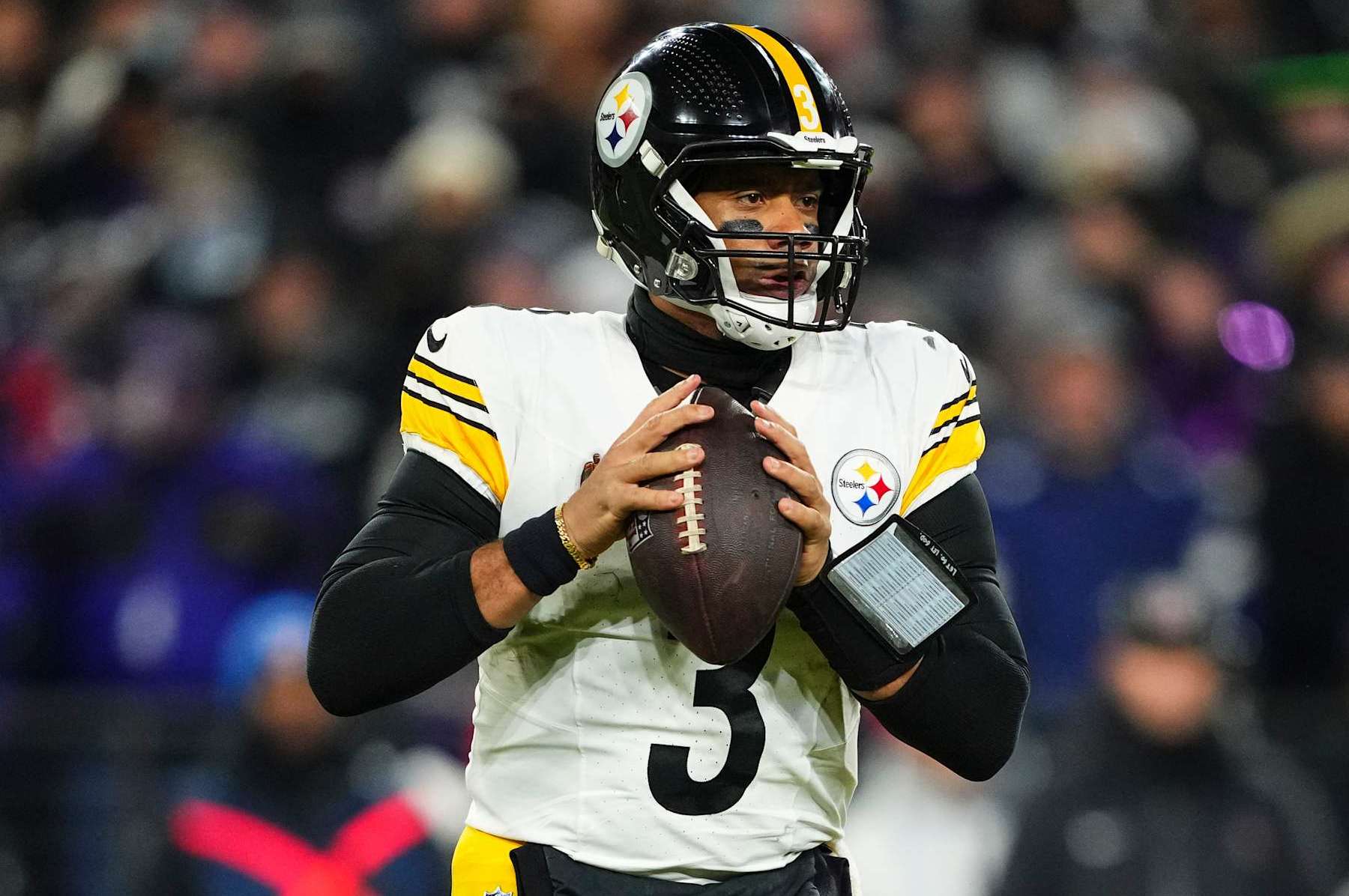 BALTIMORE, MD - JANUARY 11: Russell Wilson #3 of the Pittsburgh Steelers drops back to pass during an NFL football wild card playoff game against the Baltimore Ravens at M&T Bank Stadium on January 11, 2025 in Baltimore, Maryland. (Photo by Cooper Neill/Getty Images)