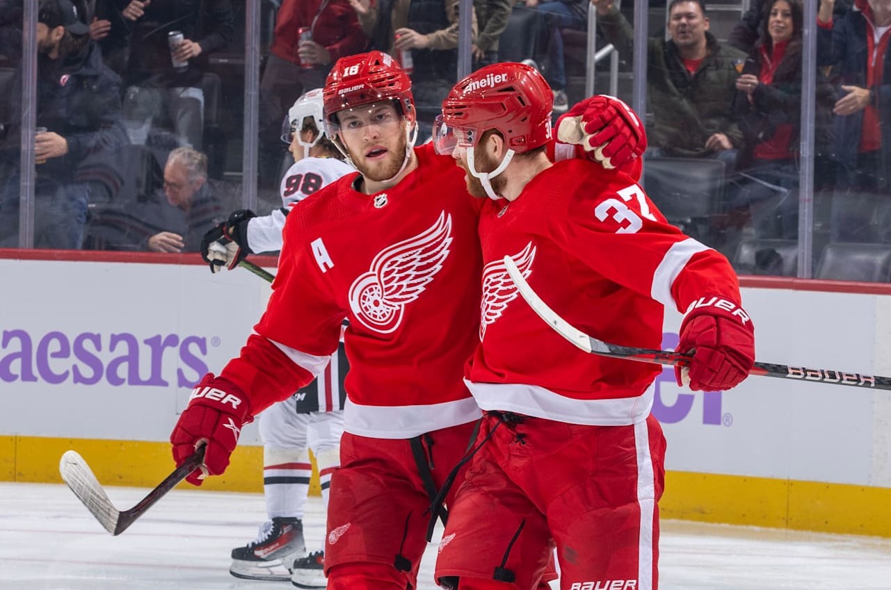 DETROIT, MI - NOVEMBER 30: J.T. Compher #37 of the Detroit Red Wings celebrates his goal against the Chicago Blackhawks with teammate Andrew Copp #18 during the first period at Little Caesars Arena on November 30, 2023 in Detroit, Michigan. (Photo by Dave Reginek/NHLI via Getty Images)