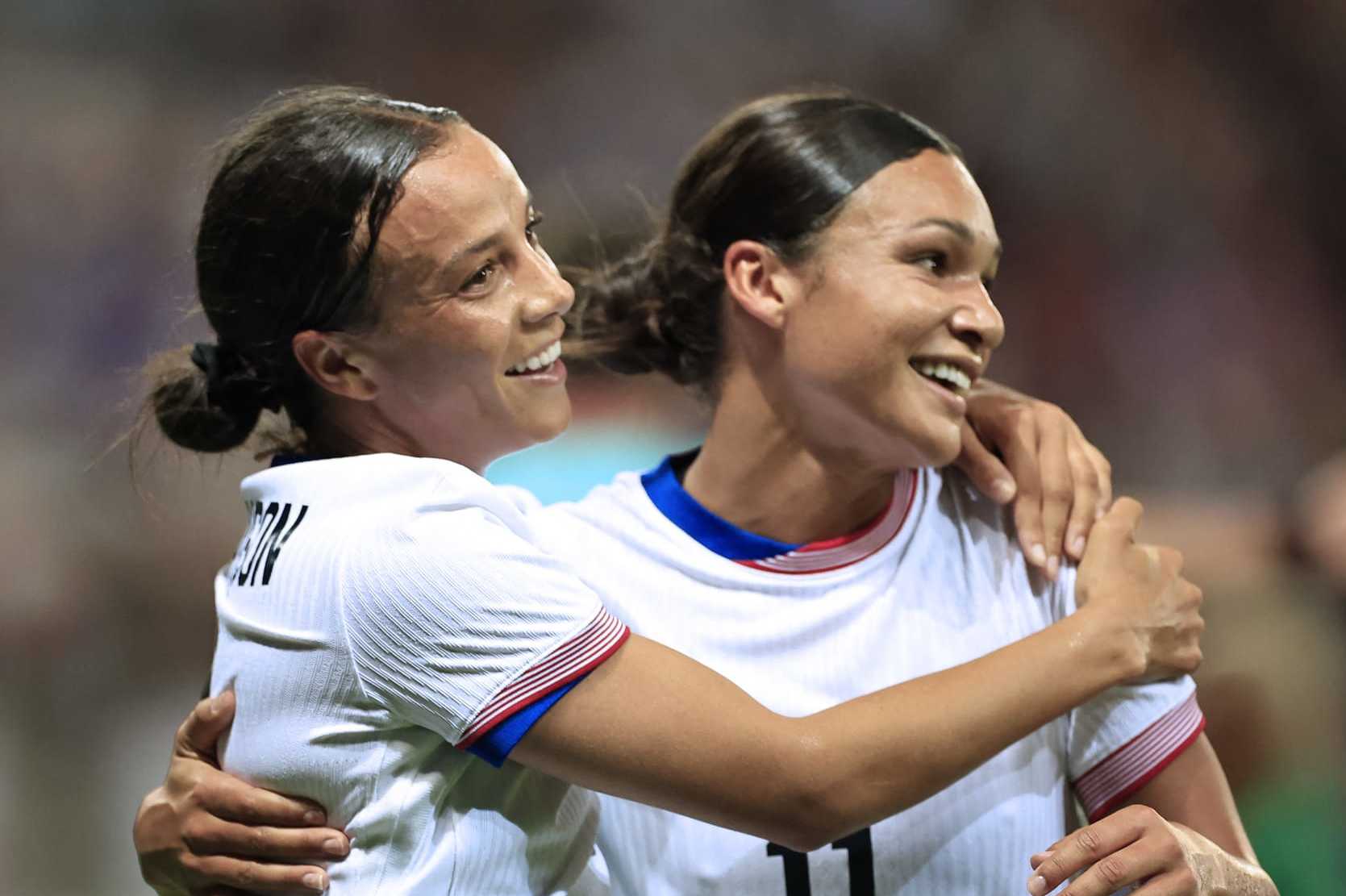US' forward #09 Mallory Swanson (L) celebrates with US' forward #11 Sophia Smith scoring her team's third goal in the women's group A football match between the USA and Zambia during the Paris 2024 Olympic Games at the Nice Stadium in Nice, on July 25, 2024. (Photo by Valery HACHE / AFP) (Photo by VALERY HACHE/AFP via Getty Images)
