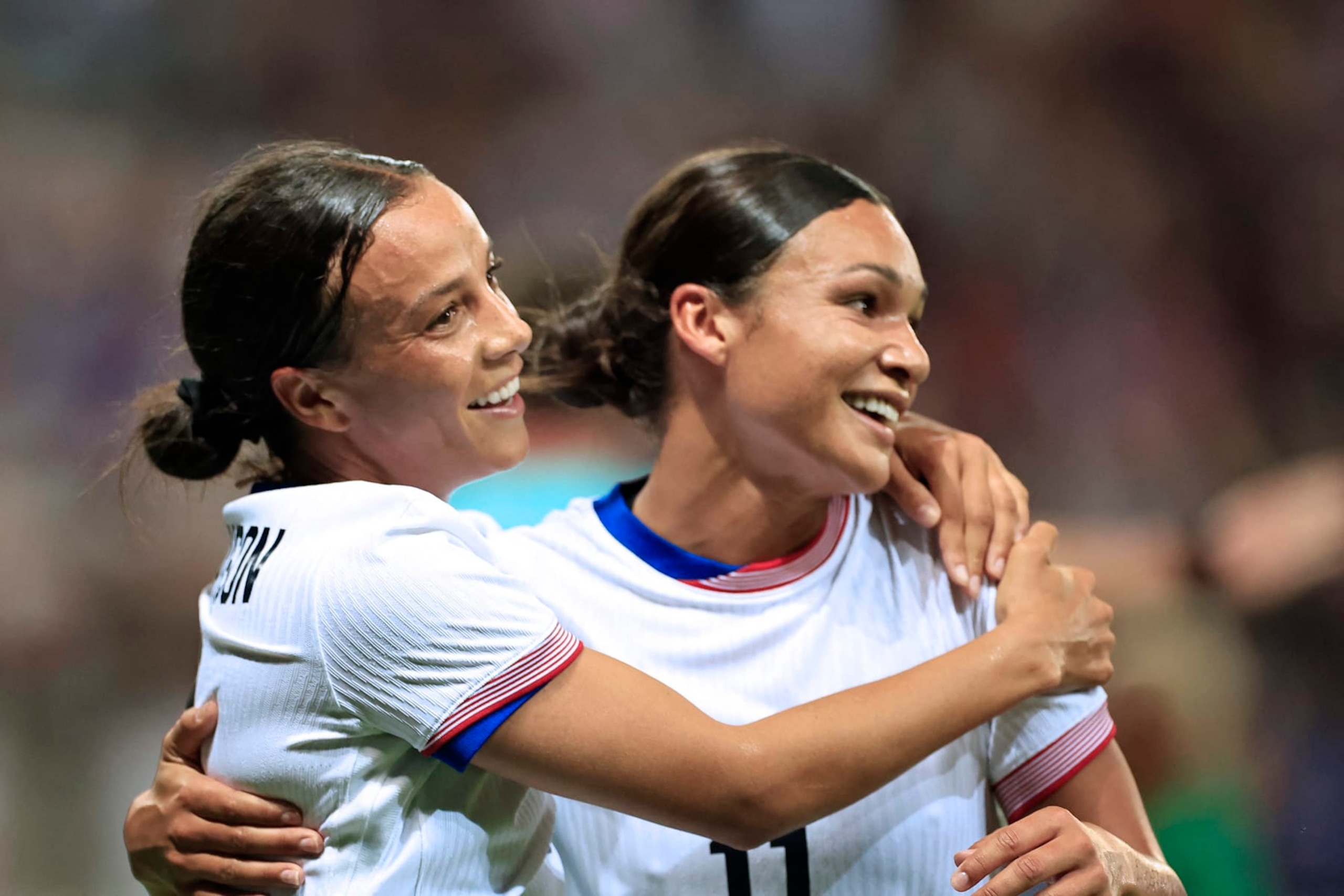 US' forward #09 Mallory Swanson (L) celebrates with US' forward #11 Sophia Smith scoring her team's third goal in the women's group A football match between the USA and Zambia during the Paris 2024 Olympic Games at the Nice Stadium in Nice, on July 25, 2024. (Photo by Valery HACHE / AFP) (Photo by VALERY HACHE/AFP via Getty Images)