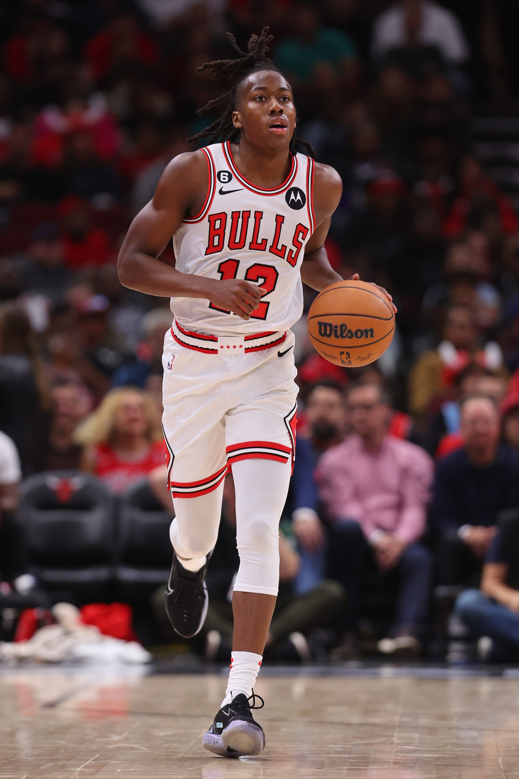 CHICAGO, ILLINOIS - OCTOBER 11: Ayo Dosunmu #12 of the Chicago Bulls dribbles onto the court against the Milwaukee Bucks during the second half of a preseason game at the United Center on October 11, 2022 in Chicago, Illinois. NOTICE TO USER: User expressly acknowledges and agrees that by downloading and/or using this photograph, the user agrees to the terms of the Getty Images License Agreement. (Photo by Michael Reaves/Getty Images)