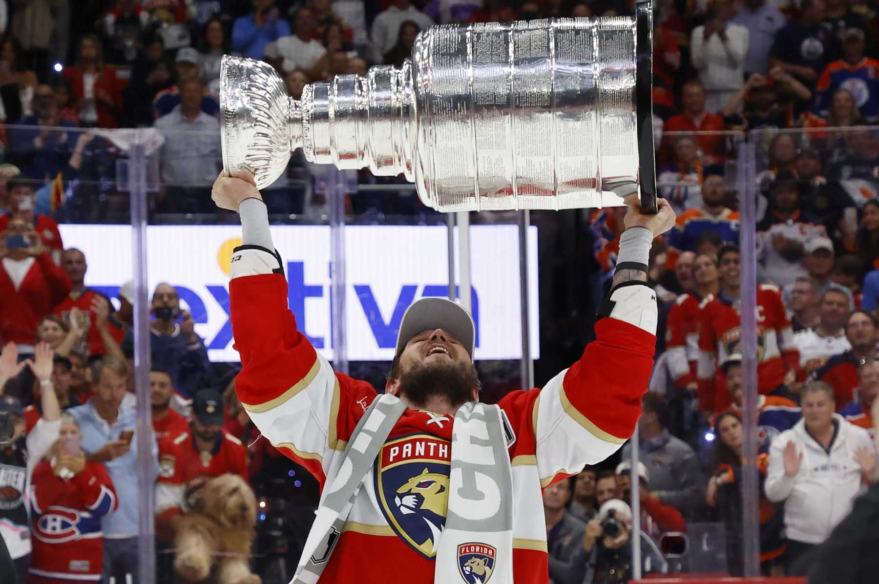 SUNRISE, FLORIDA - JUNE 24: Dmitry Kulikov #7 of the Florida Panthers hoists the Stanley Cup after a 2-1 victory over the Edmonton Oilers in Game Seven of the Stanley Cup Final at the Amerant Bank Arena on June 24, 2024 in Sunrise, Florida. (Photo by Eliot J. Schechter/NHLI via Getty Images)