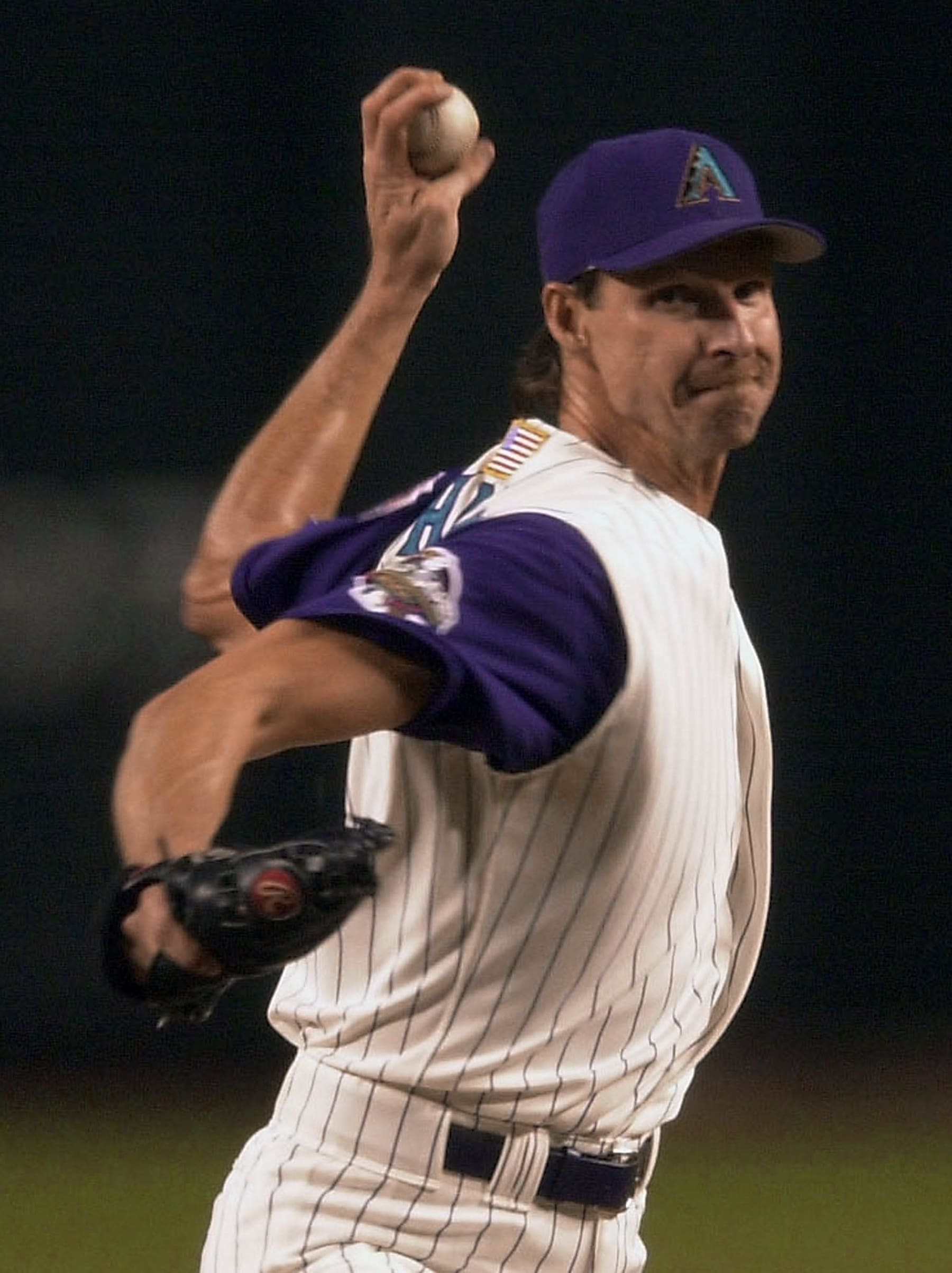 PHOENIX, AZ - NOVEMBER 3:  Arizona Diamondbacks pitcher Randy Johnson throws to the plate against the New York Yankees during the first inning of Game 6 of the World Series in Phoenix 03 November 2001. The Yankees lead the series over the Diamondbacks 3-2.  (Photo credit should read MATT YORK/AFP via Getty Images)